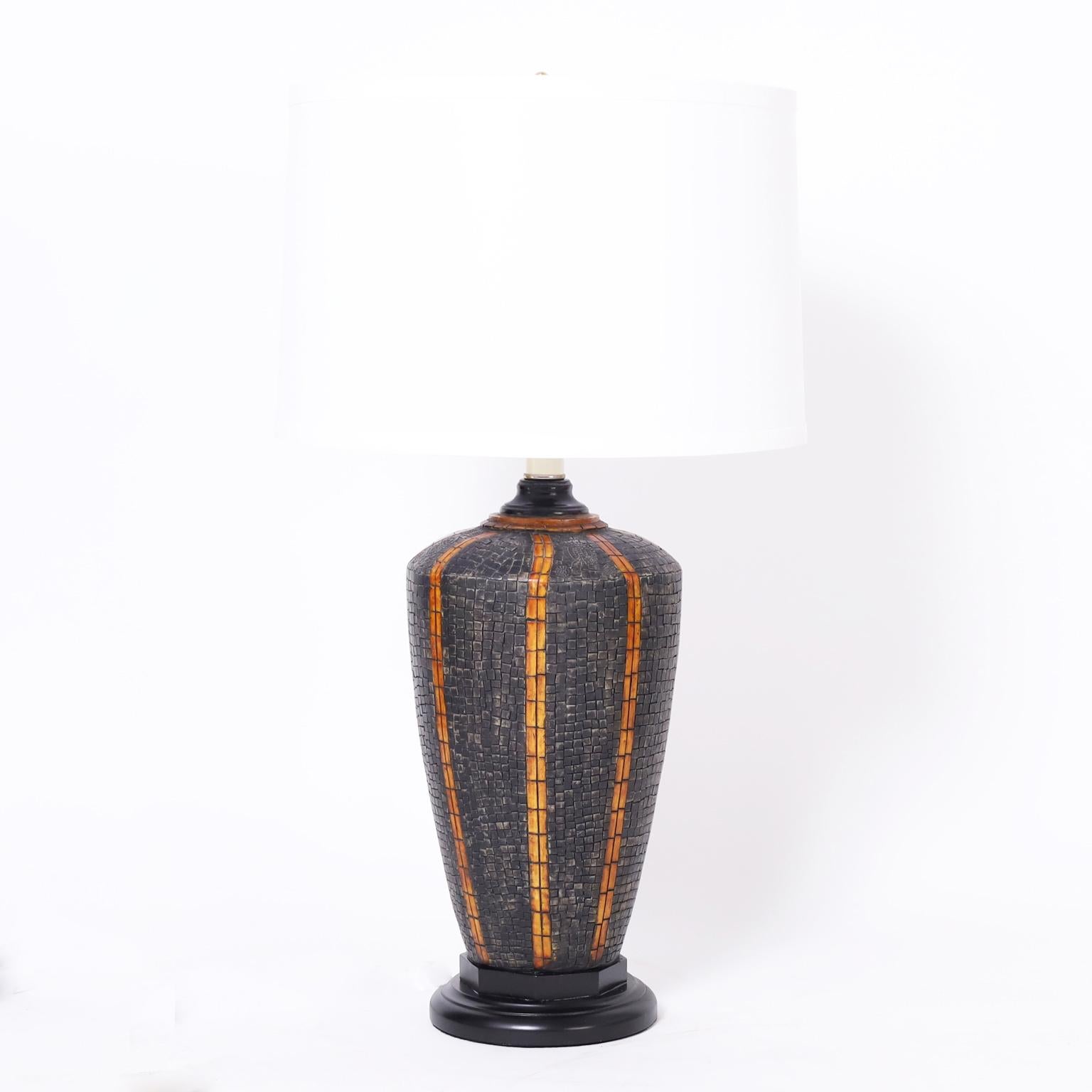 Impressive pair of mid century Italian table lamps crafted with a steer horn and dyed bone mosaic on a classic form and presented on black lacquer wood bases.