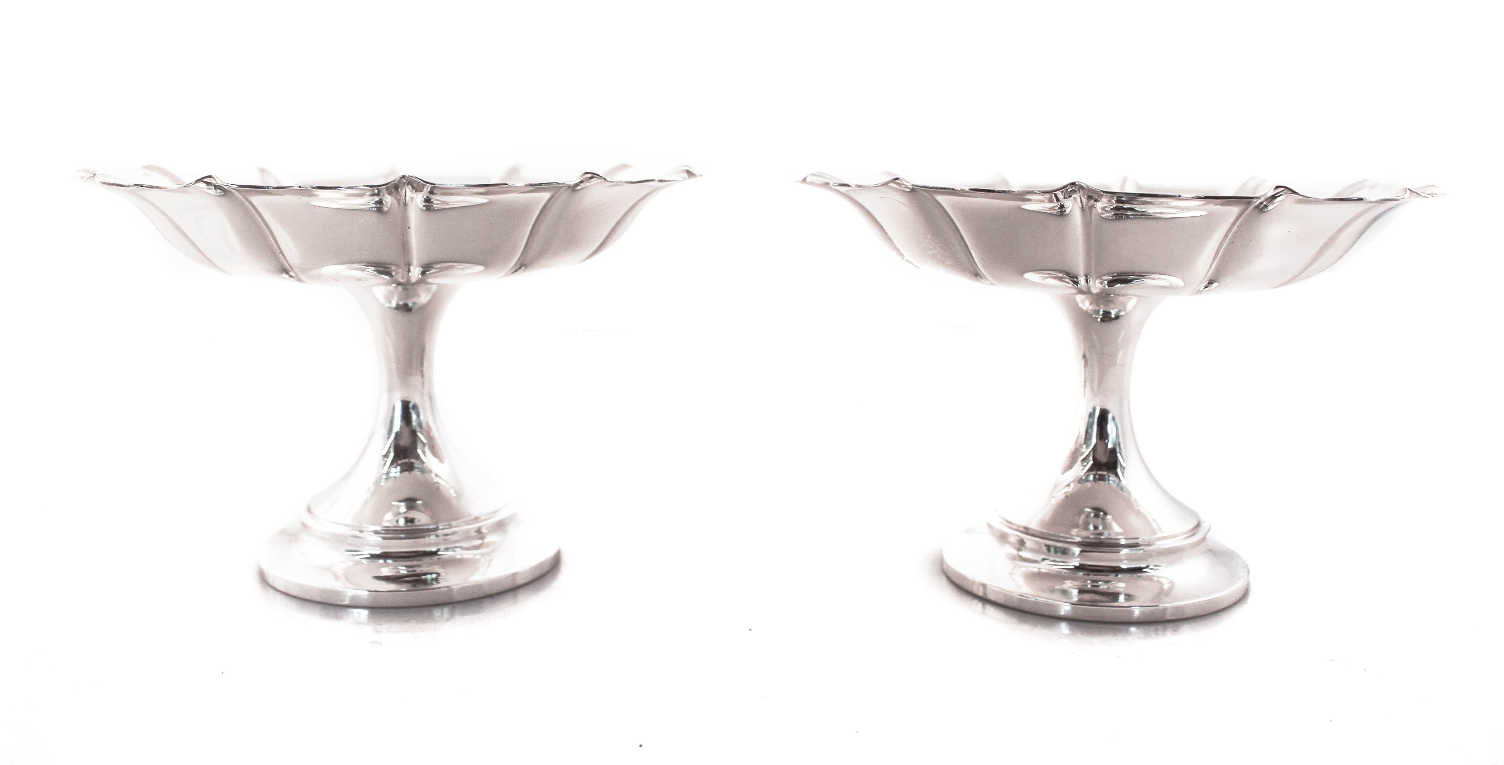 We are proud to offer this pair of sterling silver compotes by Tuttle Silversmiths of Boston, Massachusetts. They were designed in the “Irish” pattern with only a scalloped rim. They are understated and elegant. They have a “CC” in the hallmark that