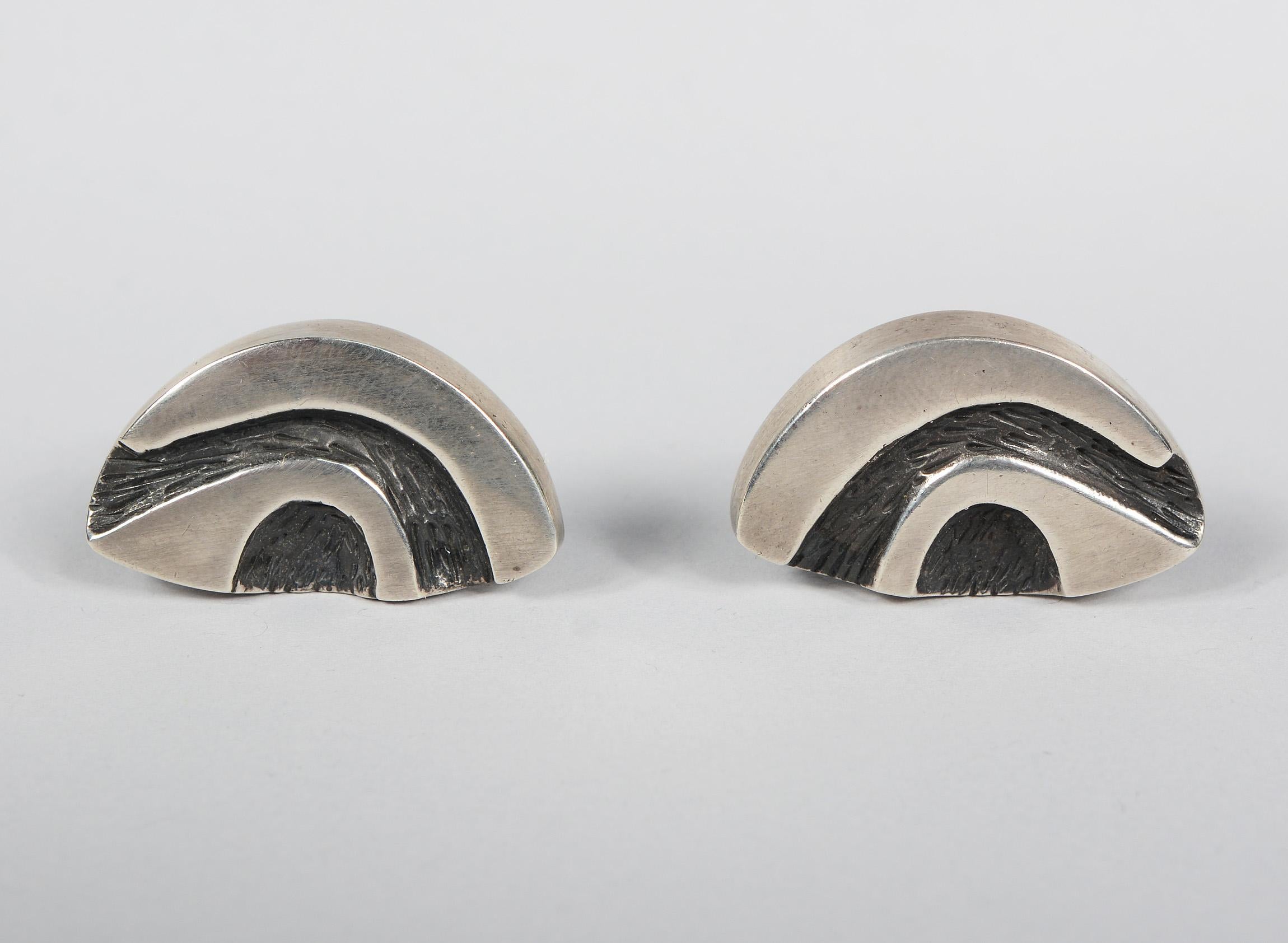 Pair modernist cufflinks in sterling. These are cast, polished and tooled in the recess area. They are not signed.