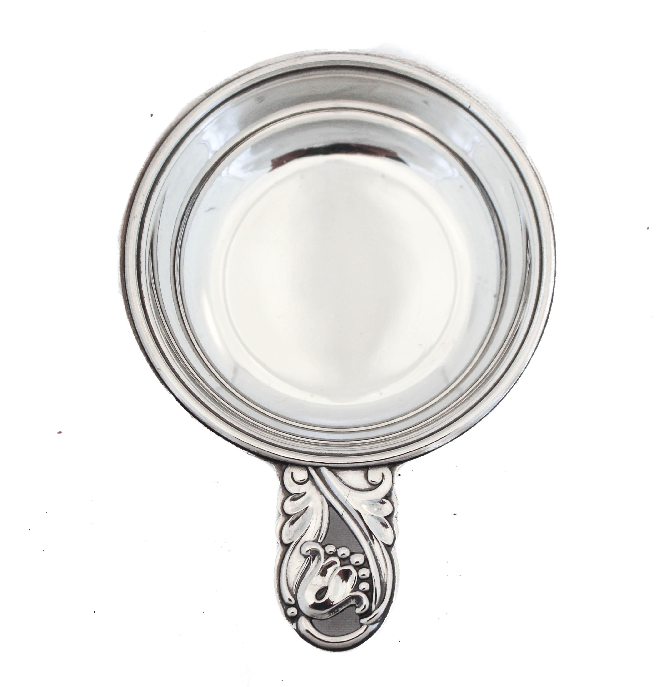 We are happy to offer you this pair of sterling silver salt cellars in the “Spring Glory” pattern by International Silver. Each cellar has a handle with its signature design. 
“Spring Glory” would go on to become one of the most popular patterns of