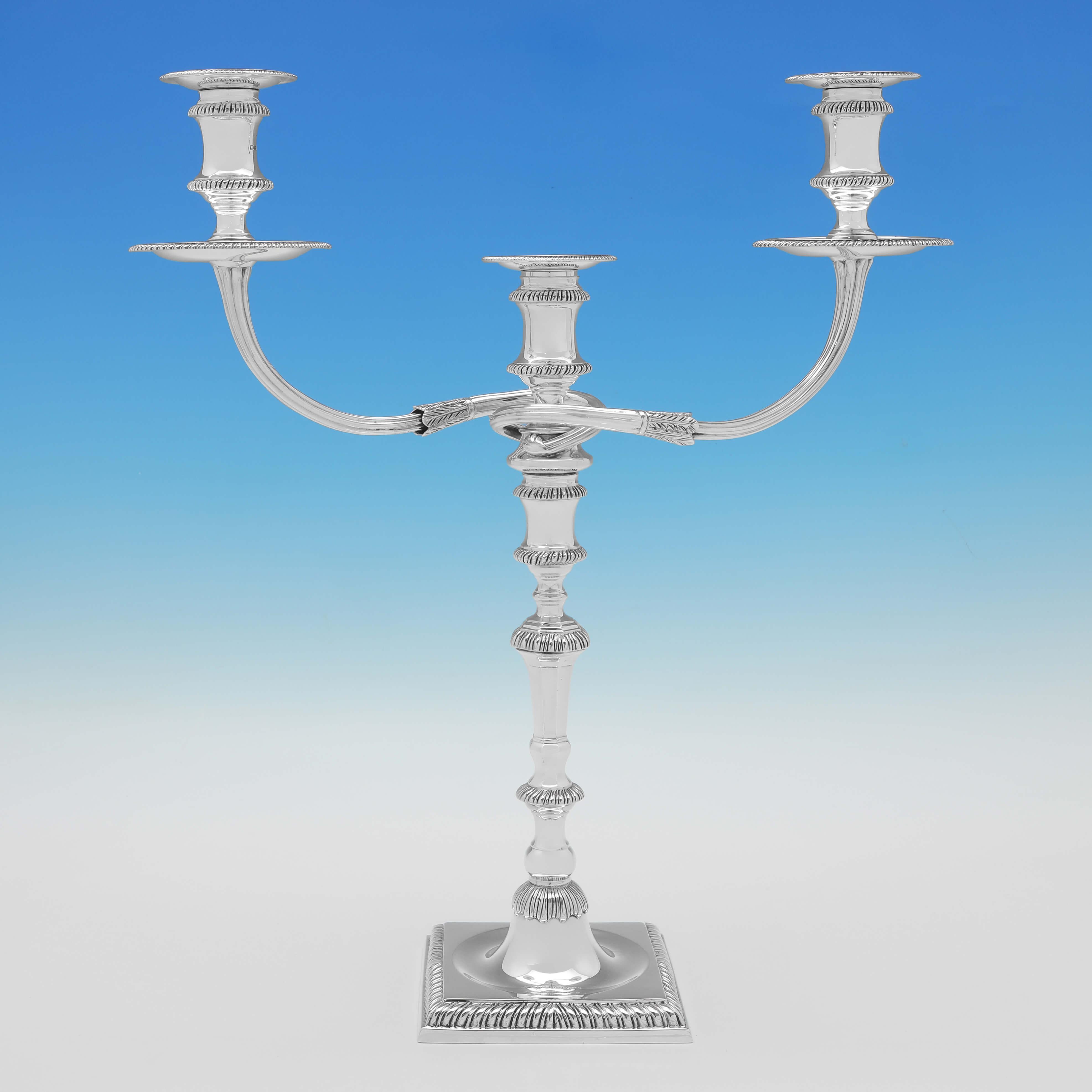 Hallmarked in London in 1959 this handsome pair of Sterling Silver Candelabra, are cast and are faithful reproductions of a George III style. 

Each candelabrum measures 16