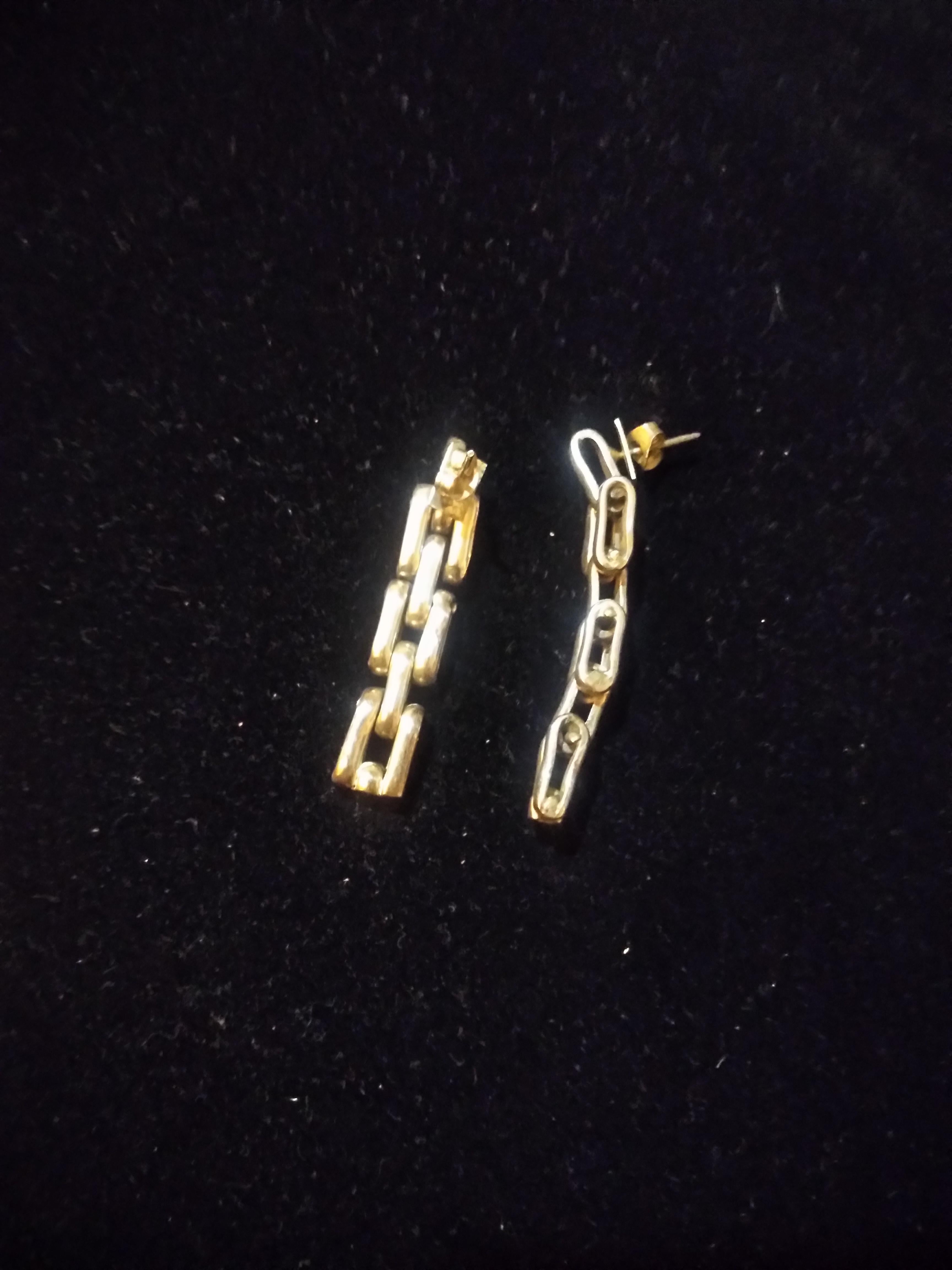 This is a nice looking pair of earrings. They're made of sterling silver and are shaped like a linked chain. 