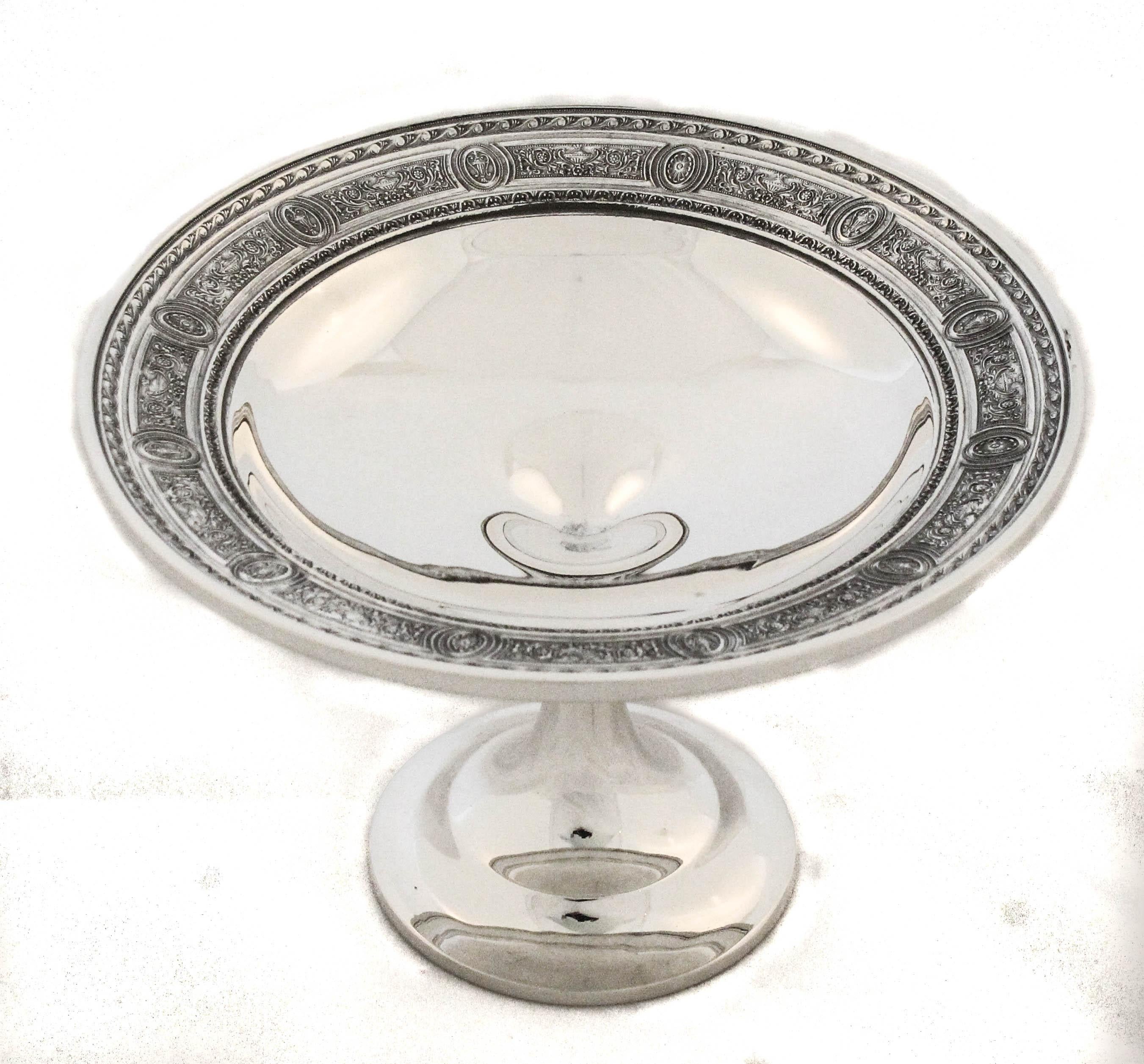 A graceful pair of sterling silver compotes by International Silver in the elegant “Wedgewood” pattern, first introduced in 1924. These refined serving pieces feature the iconic Wedgewood motif—a delicate, classical garland design—encircling the
