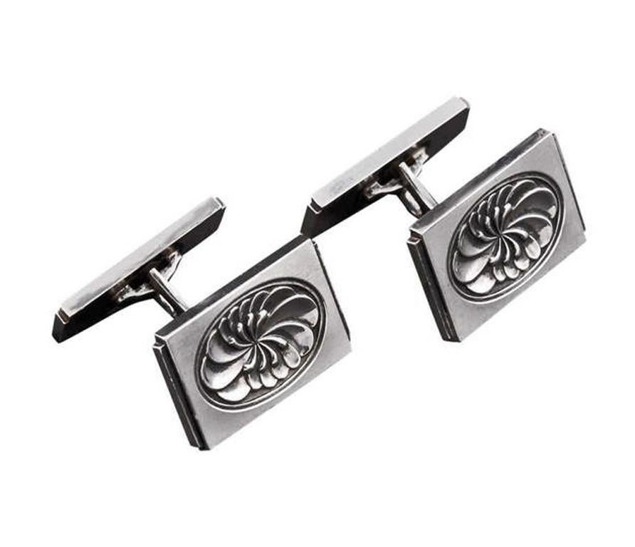 Pair of sterling silver Georg Jensen cufflinks, #59, Denmark, C.1935, designed by Henry Pilstrup. The cufflinks, lotus design, of rectangular shaped double sided form with oval foliage concave centre. Each stamped Sterling Denmark GJ in rectangular