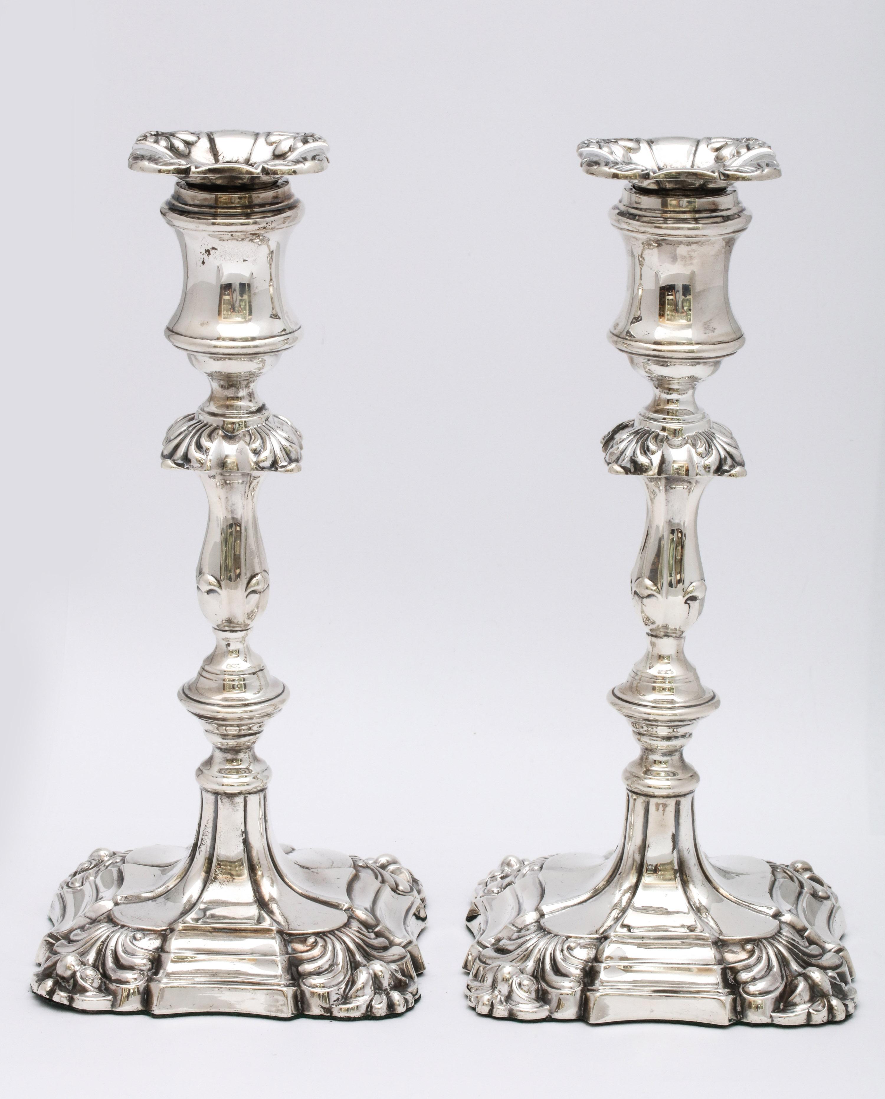 Pair of sterling silver, Georgian-style (George III) candlesticks, Sheffield, England, 1905, Walker and Hall - makers. Measures 9 1/4 inches high x 4 inches wide (at widest point) x 4 inches deep (at deepest point). Removable bobeches. Weighted.
