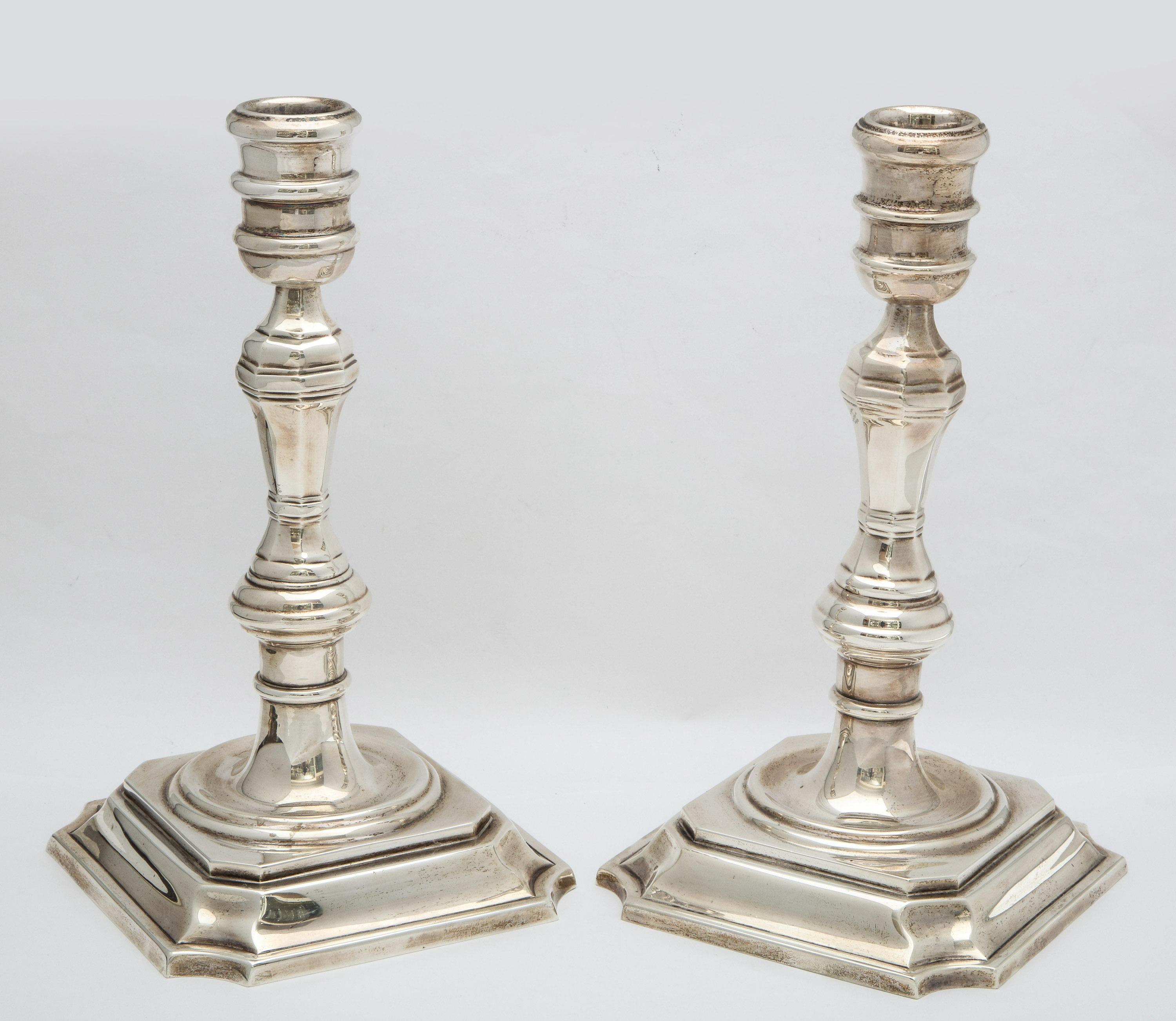 Pair of sterling silver, Georgian style (George III) candlesticks, Mexico, mid-20th century, Tane - maker. Each measures 9 1/2 inches high, base measures 5 1/4 deep x 5 1/4 wide. Not weighted, the pair weighs 32.510 troy ounces. Dark spots in photos