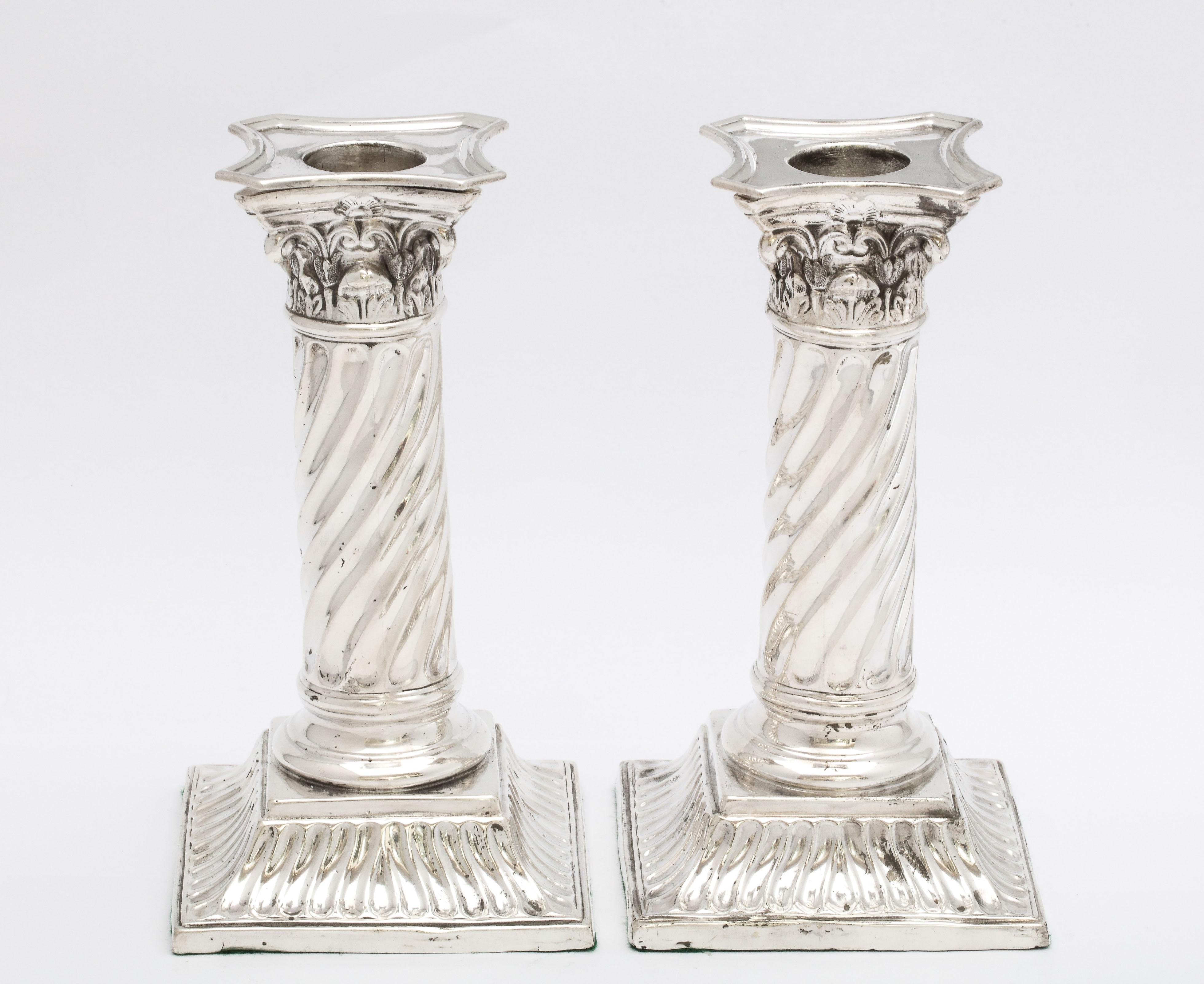 Pair of sterling silver, neoclassical, Corinthian column candlesticks with swirled columns, London, 1890, Richard Martin and Ebenezer Hall - makers. Each measures 6 inches high x 3 inches wide x 3 inches deep. Weighted. Bobeches are removable. Minor