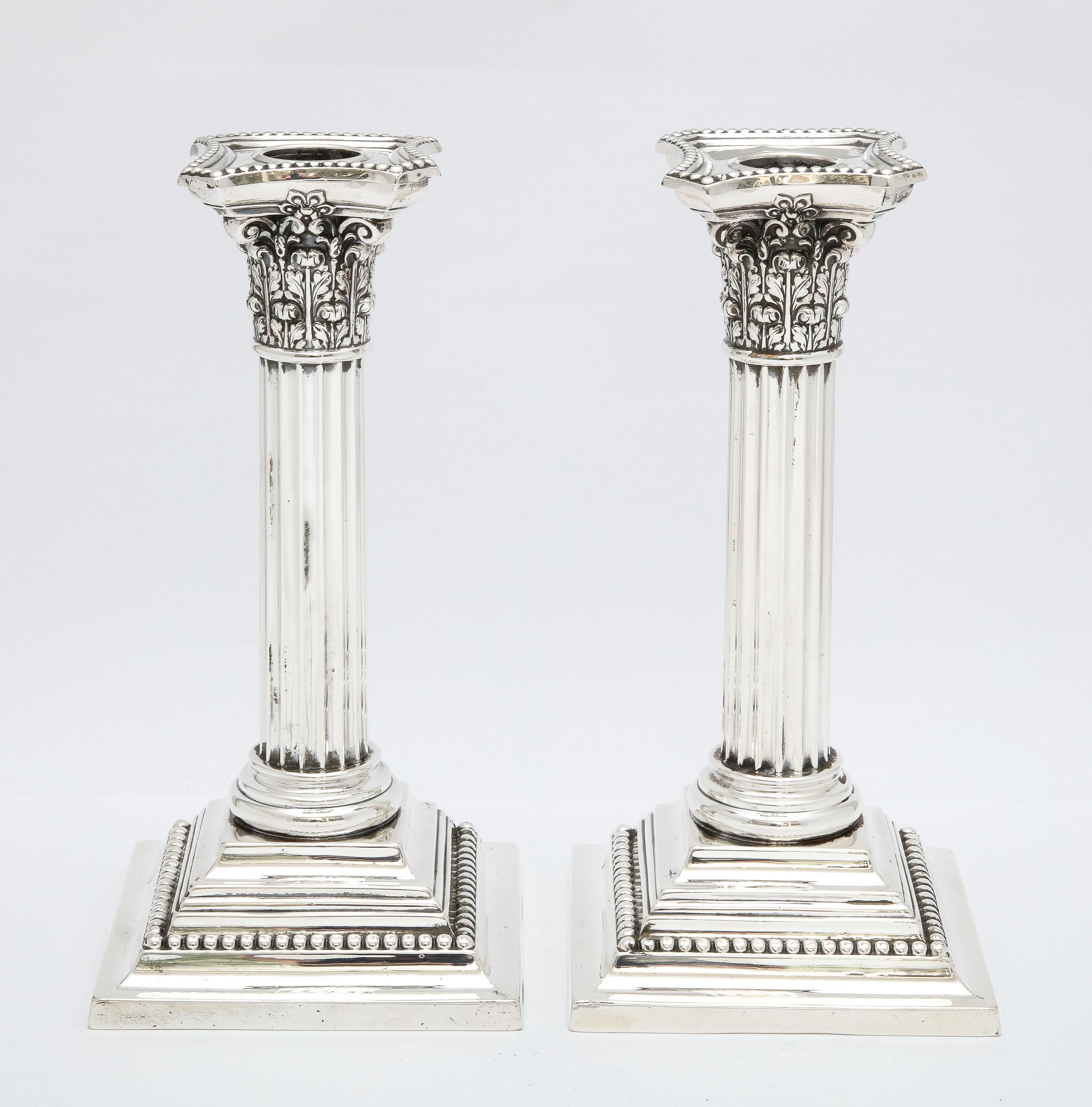 Pair of Edwardian Period, sterling silver, neoclassical-Style Corinthian Column candlesticks, Gorham Manufacturing Corp., Providence, Rhode Island, year-hallmarked for 1906. Each candlestick measures 8 1/4 inches high x 4 1/4 inches wide (at widest