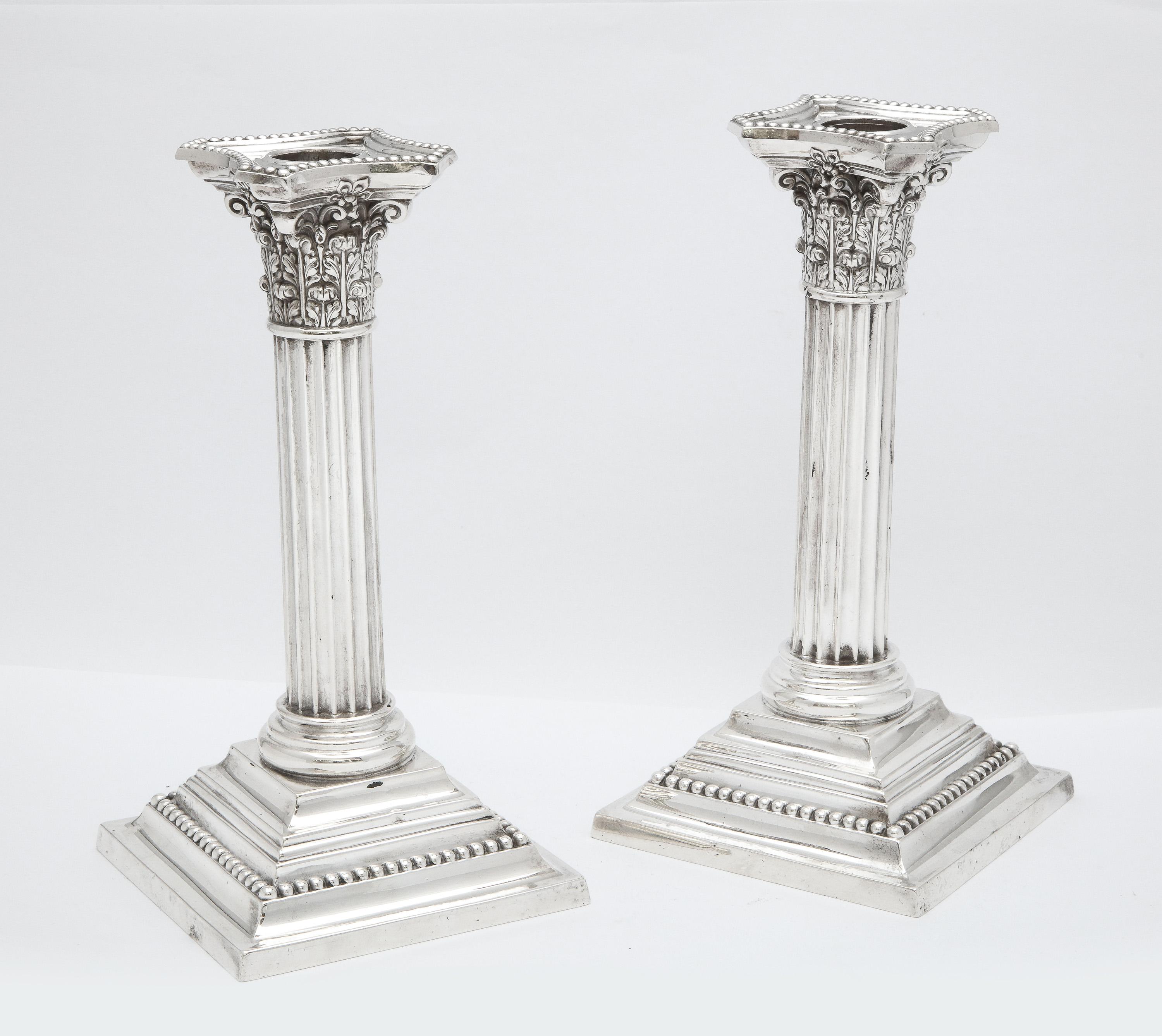 Pair of Edwardian period, Neoclassical-Style sterling silver candlesticks, Gorham Manufacturing Co., Providence, Rhode Island, year-hallmarked for 1906. Each candlestick measures 8 1/4 inches high x 4 1/4 inches deep (across base) x 4 1/4 inches