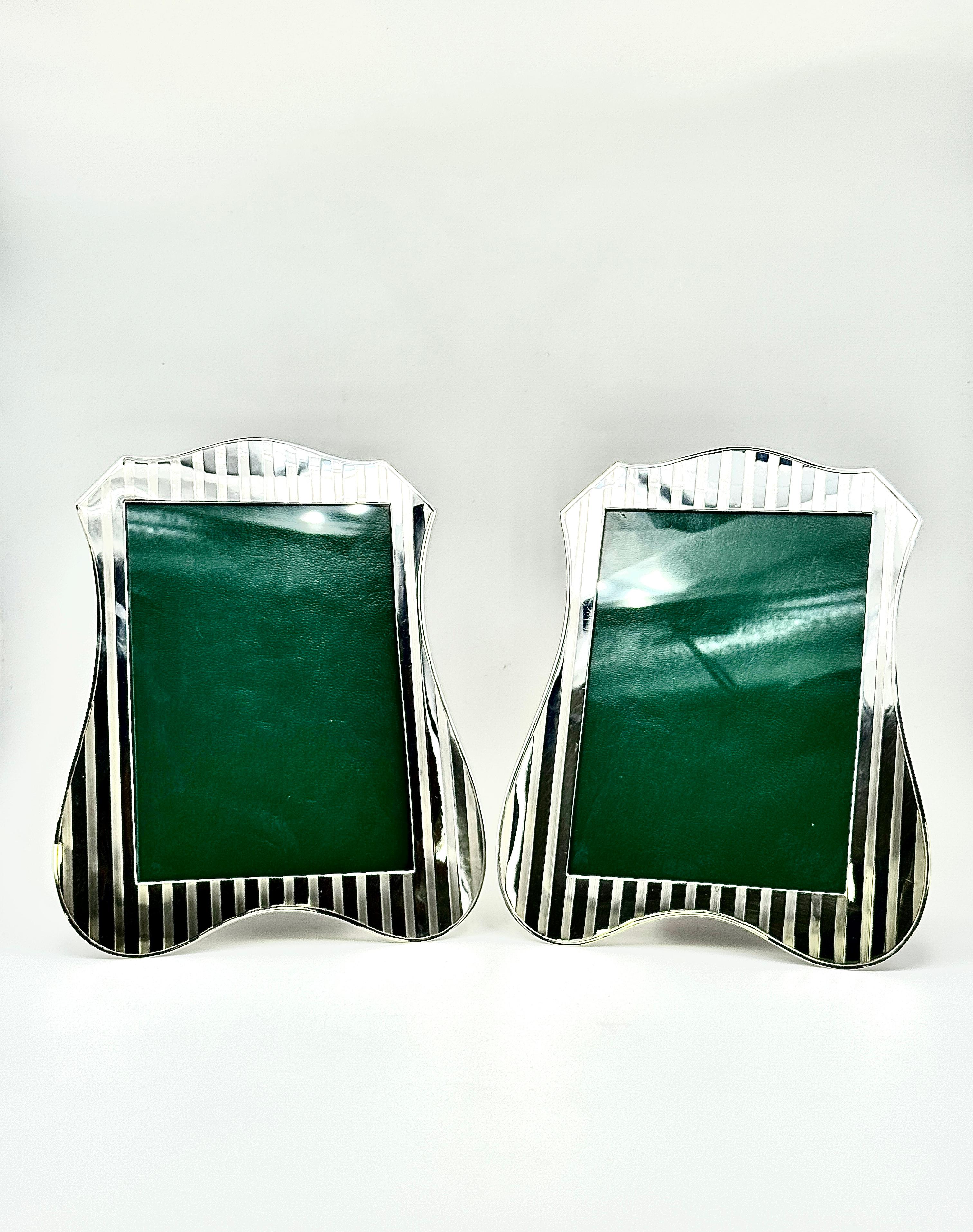 Pair of English Sterling Silver Photograph Frames, hallmarked Birmingham 1919 and with the retailer mark of A.J Pepper & Co. Ltd.
The stylish frames are decorated with vertical stripes that are formed through engine-turned engraving that achieves a