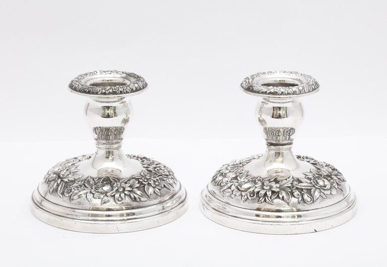 Pair of sterling silver, Victorian-style, Repousse pattern candlesticks, S. Kirk and Sons, Baltimore, Maryland, Ca 1930's. Each candlestick measures 3 3/4 inches high x 4 1/4 inches diameter across its base. Weighted. One candlestick has some very