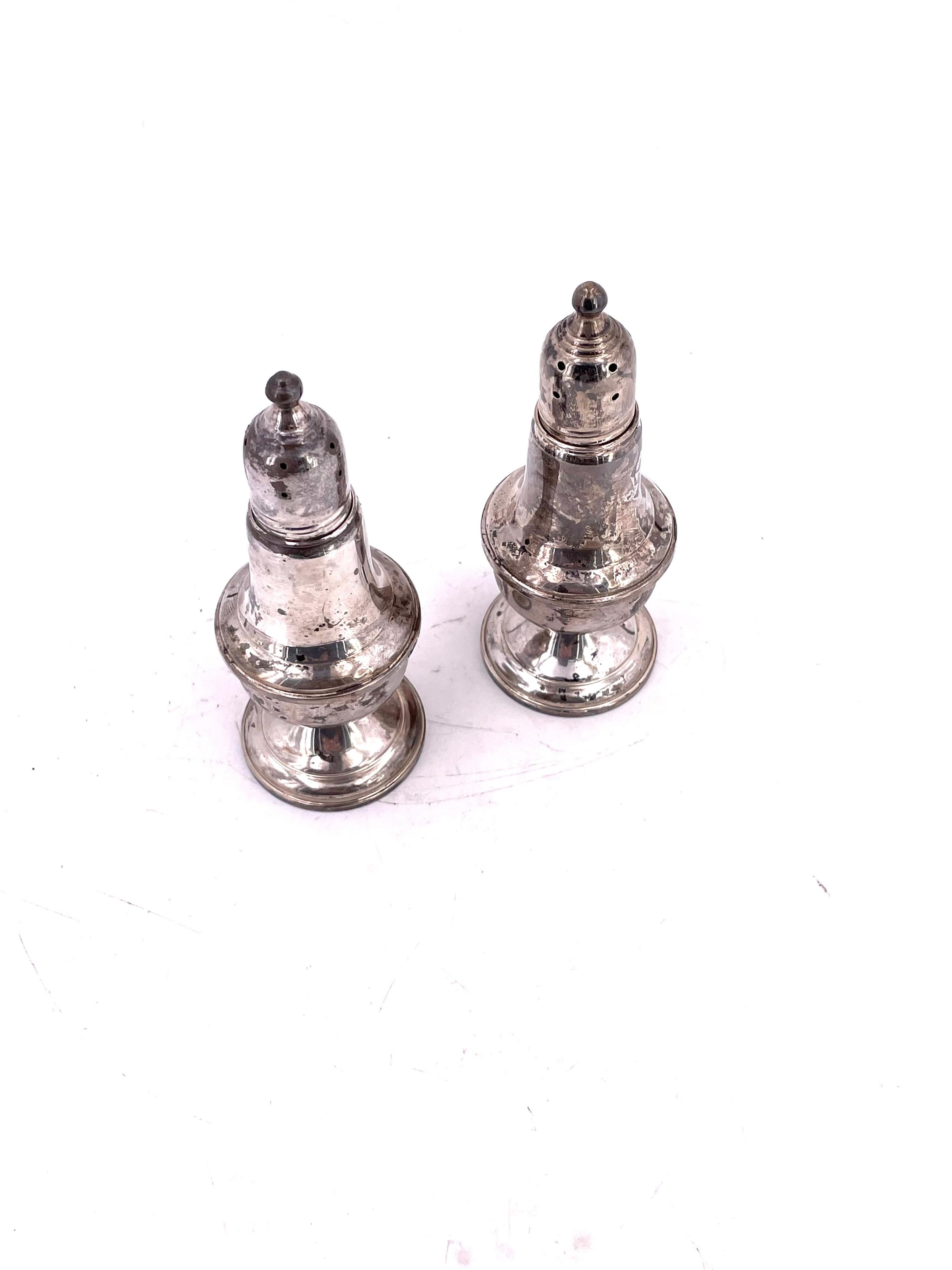 Elegant pair of antique sterling silver salt and pepper shakers by Empire, circa 1940's natural tarnish and patina due to age can be polished with glass inserts, nice condition.