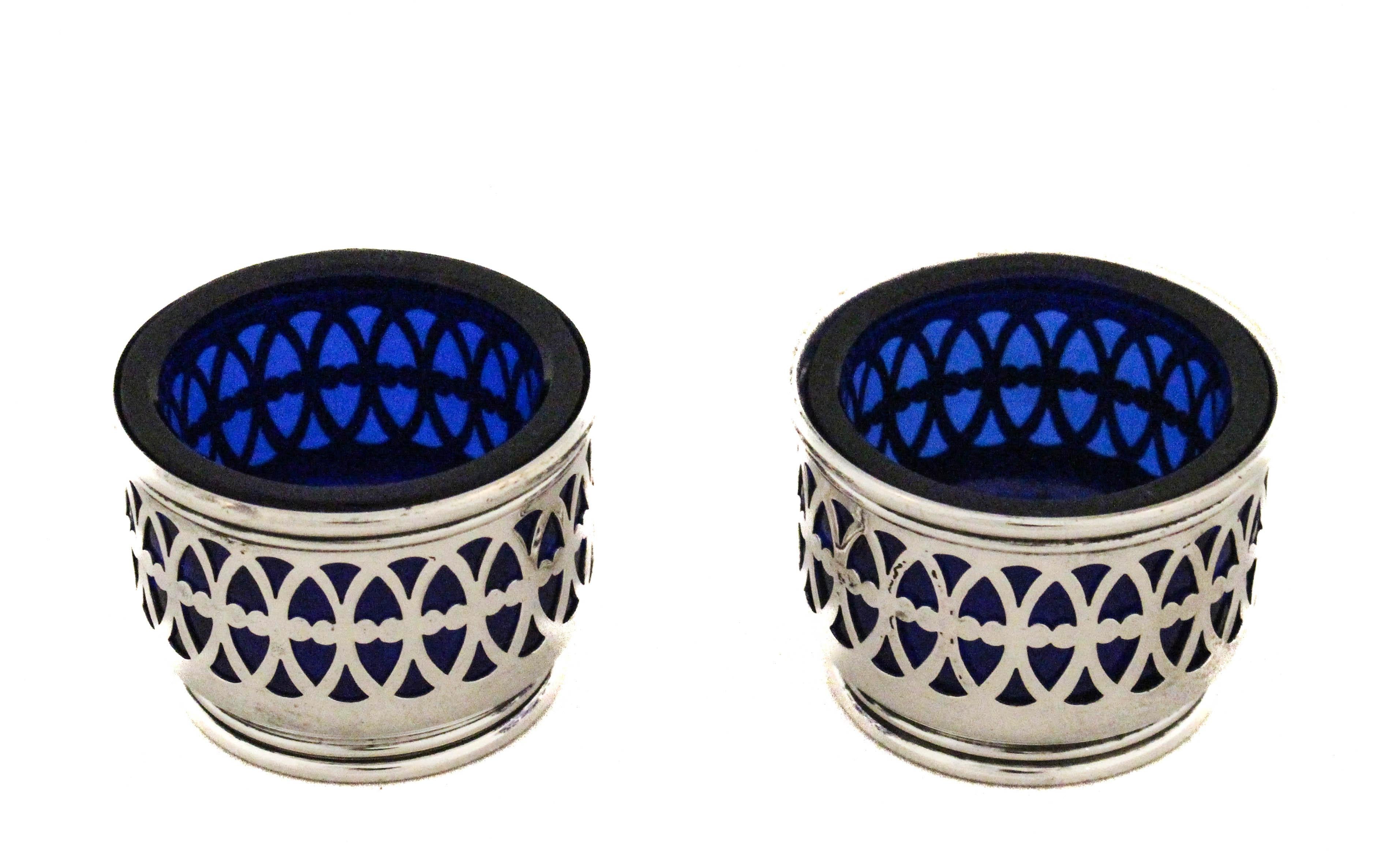 This exquisite pair of sterling silver salt cellars was crafted by Gorham Silversmiths and showcases the fine artistry and attention to detail for which the company is renowned. Each cellar features a delicate and symmetrical reticulated design