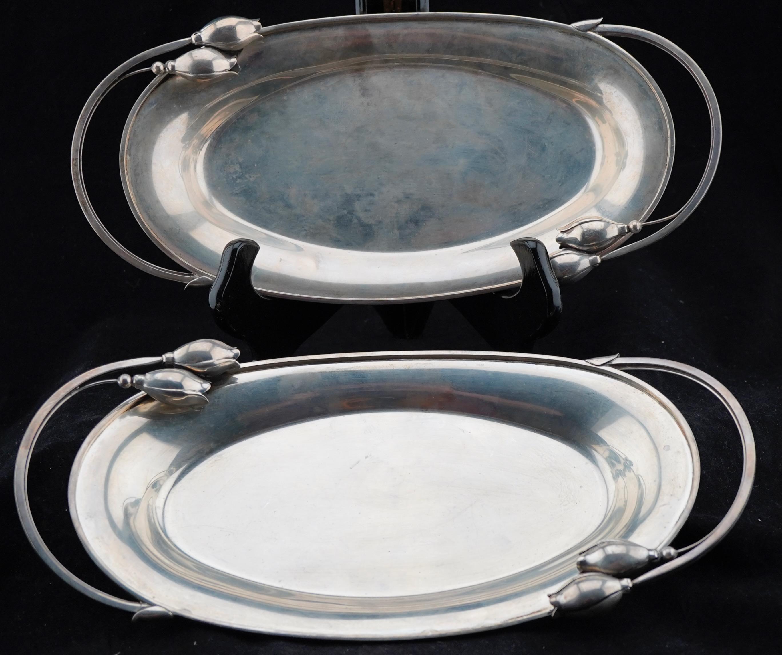 Pair of mid-century Modern sterling silver serving dishes, Designed by Alphonse La Paglia (d. 1953) for International Silver Co. in Meriden, Conn. Decorated with stylized flowers. Both dishes are marked.  Each dish is 12.25x6.25x1.75