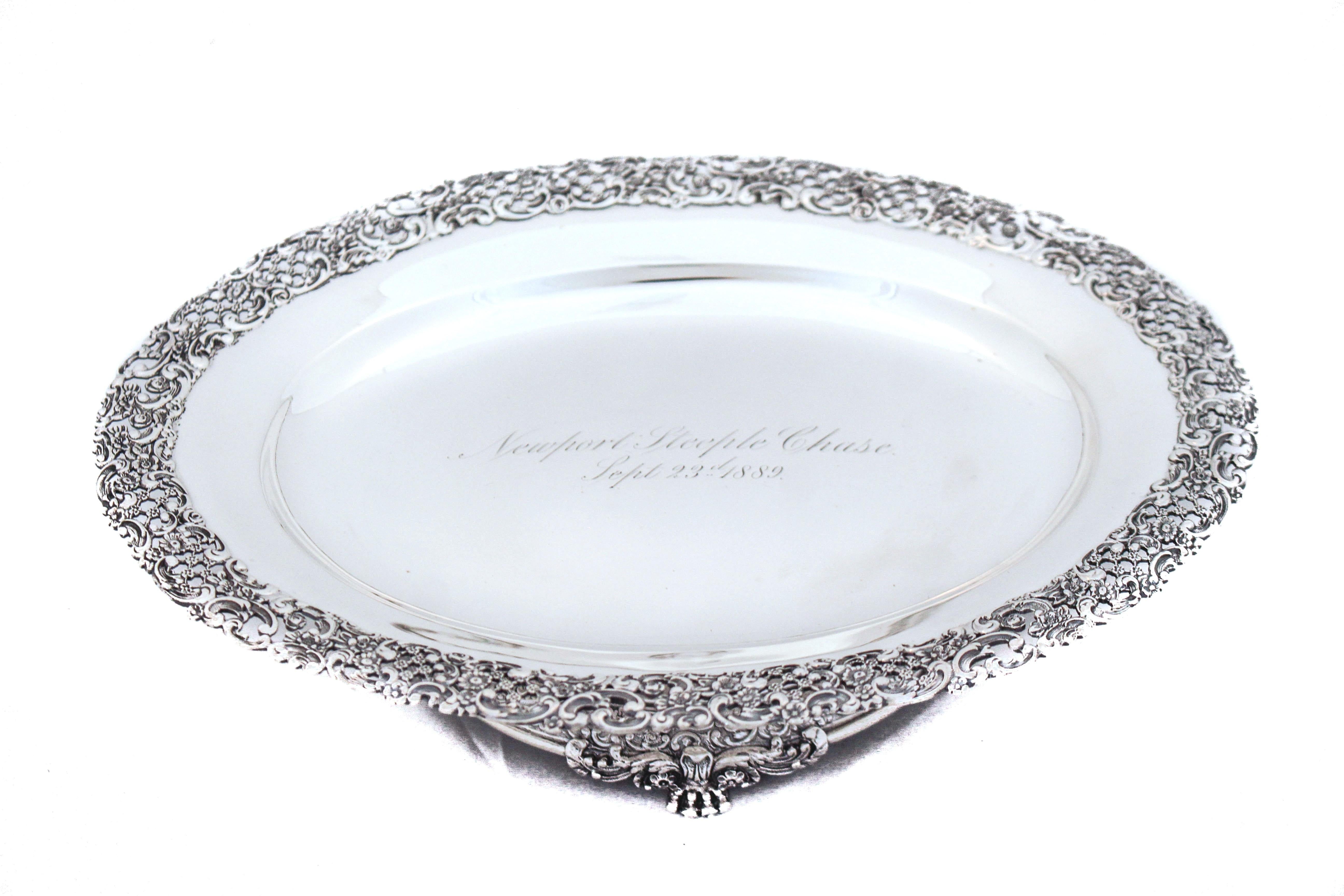 An extraordinary pair of sterling silver tazzas by the world renowned Tiffany and Company.  They are oval in shape and stand on pedestals.  They have a floral reticulated design going around the edge and the same design around the base.  Each one is