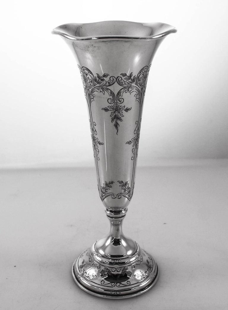 We are proud to offer this pair of sterling silver vases by Black, Starr and Frost from the early 20th century. They have fine etchings around the base and along the shaft. The rim is scalloped and opens out so your flowers can fit perfectly.