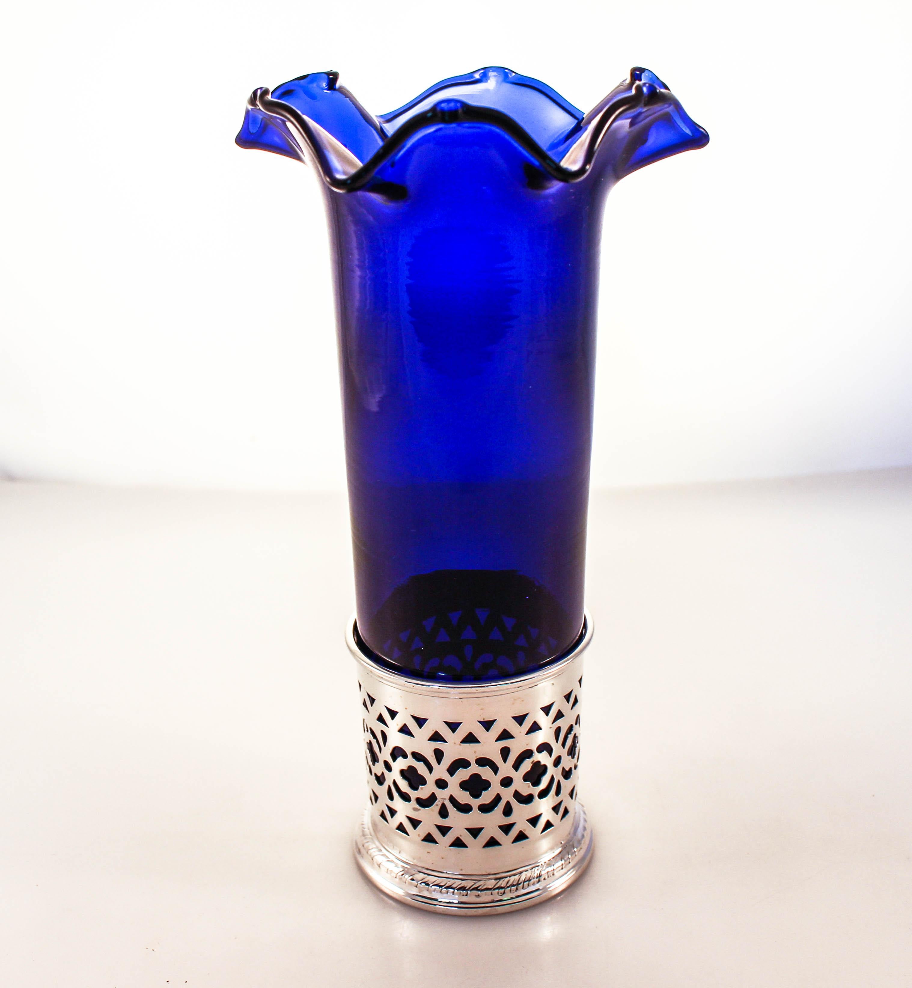 We are delighted to offer this pair of sterling silver vases with cobalt glass liners. Made by the Meriden Britannia Co of Connecticut, the silver vase has a beautiful latticework pattern and rising up from within is a deep cobalt glass insert. It