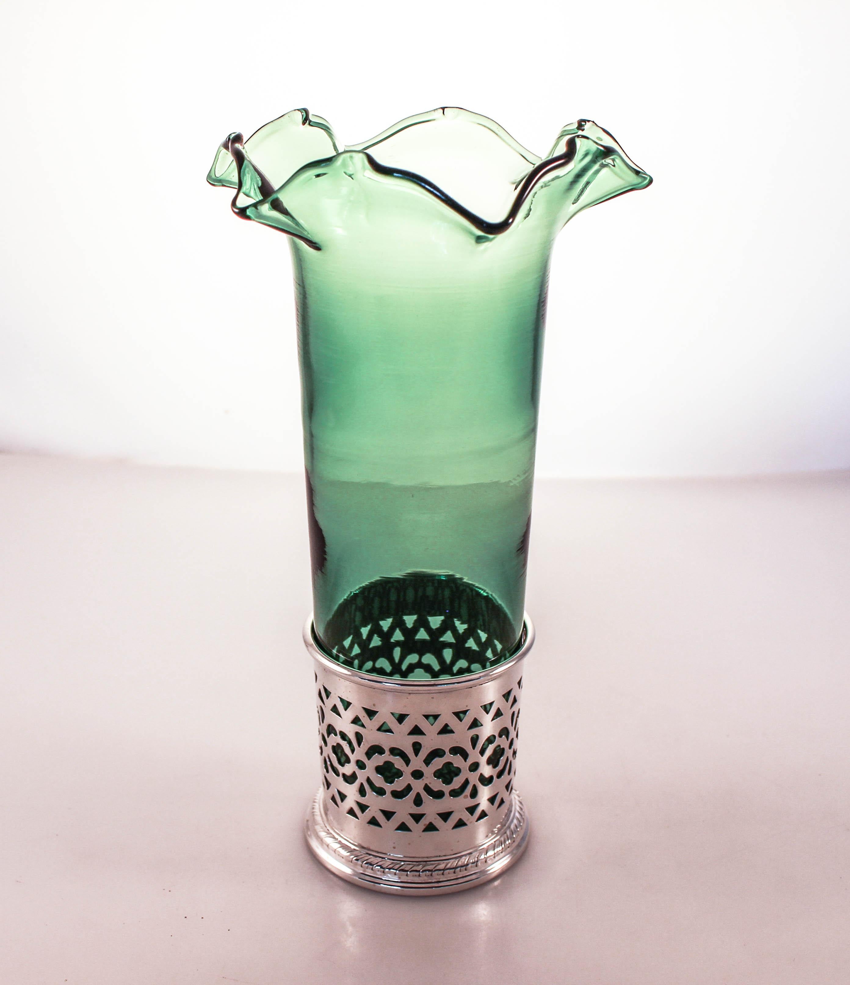 We are delighted to offer this pair of sterling silver vases with green glass liners. Made by the Meriden Britannia Co of Connecticut, the silver vase has a beautiful latticework pattern and rising up from within is a luscious green glass insert. It