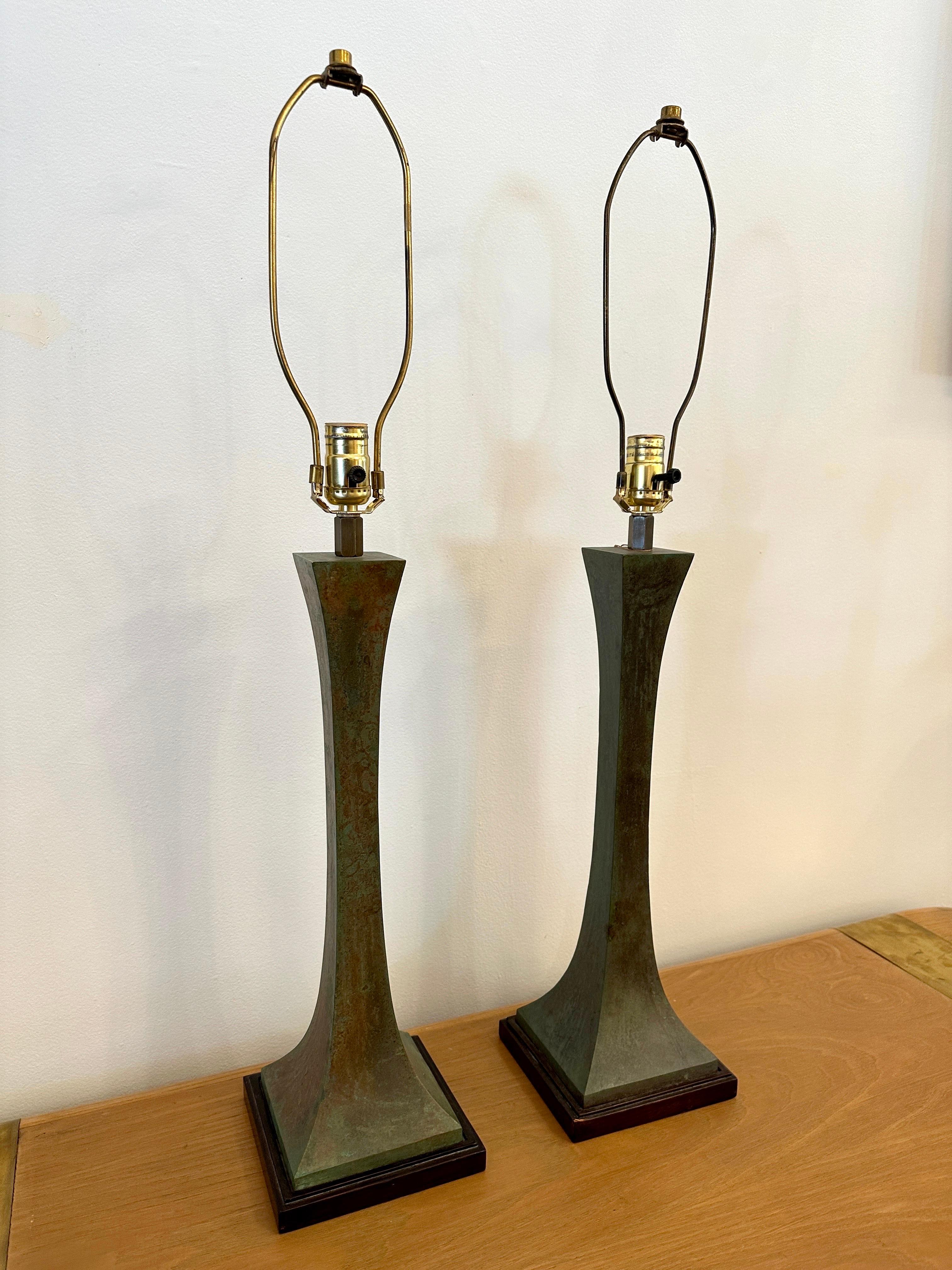 These lovely verdigris bronze patinated lamps are designed by Stewart Ross James for Hansen.  In working condition with original wiring and single standard bulb. The elegant double pyramidal design of these bronze table lamps give them a classical