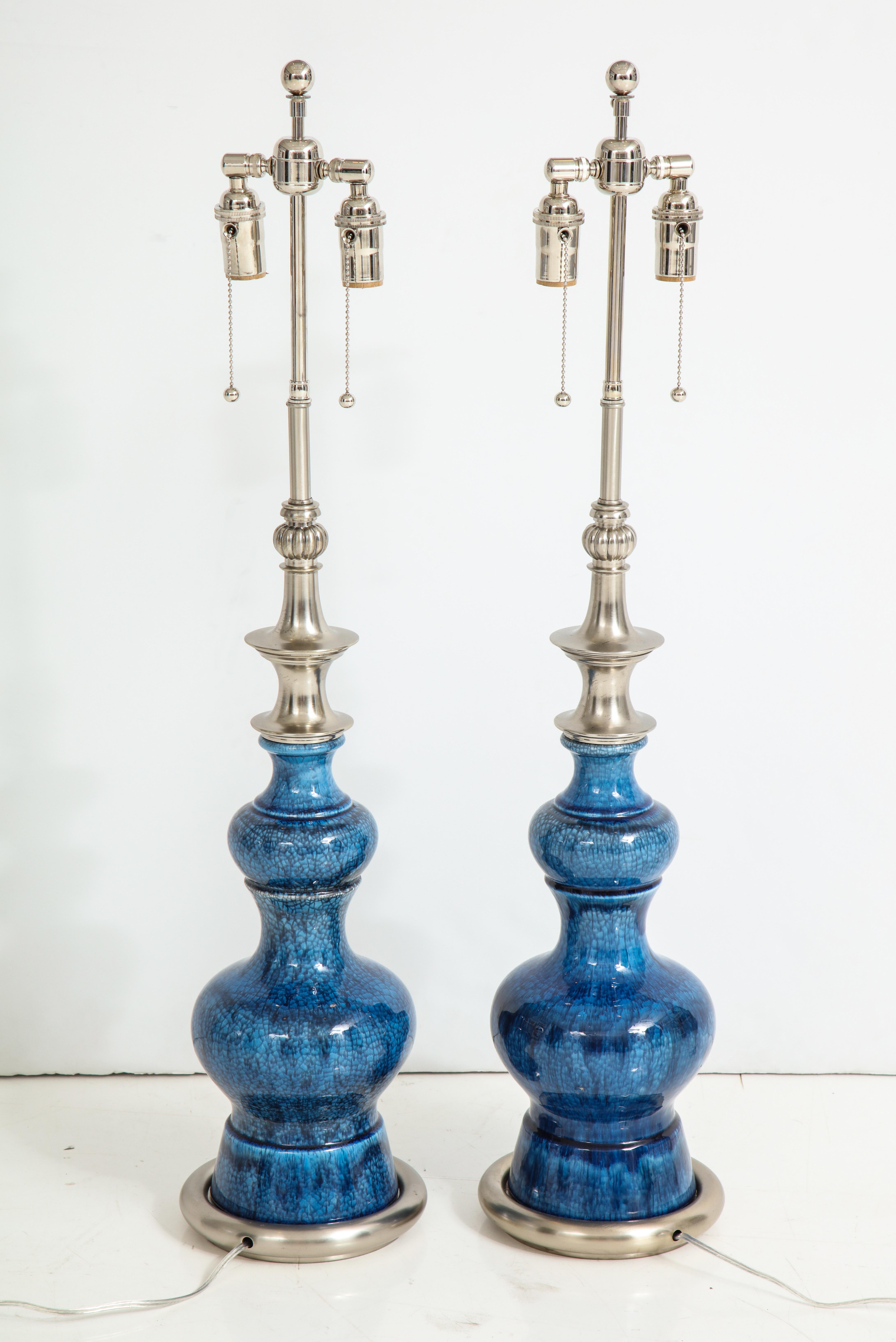 Pair of large 1960s Stiffel ceramic lamps with a beautiful blue crackle glaze finish.
The lamps are mounted on brushed satin nickel bases and nickel hardware.
They have been newly rewired for the US with double clusters that take standard light