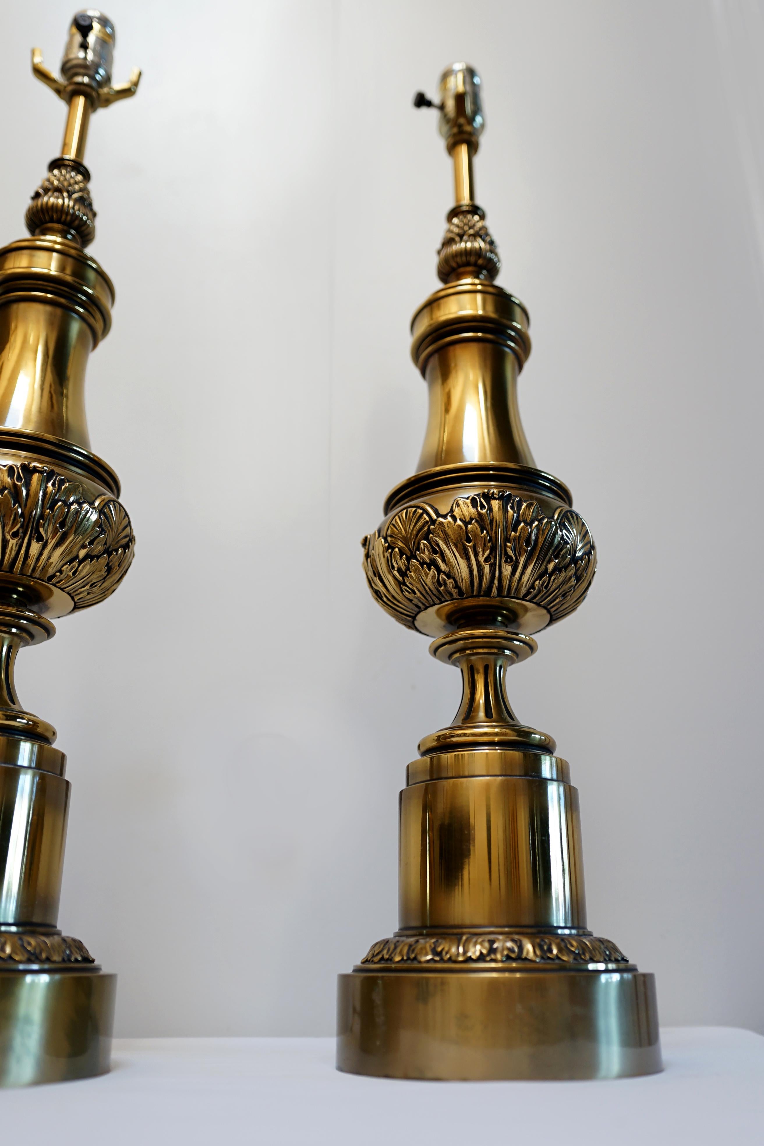 This is an extraordinary pair of Stiffel lamps in size, design and presence. The pair are vintage Stiffel brass columnar lamps from the mid to late 20th Century. They are a decorating asset. There is a vintage feel, but the execution and condition