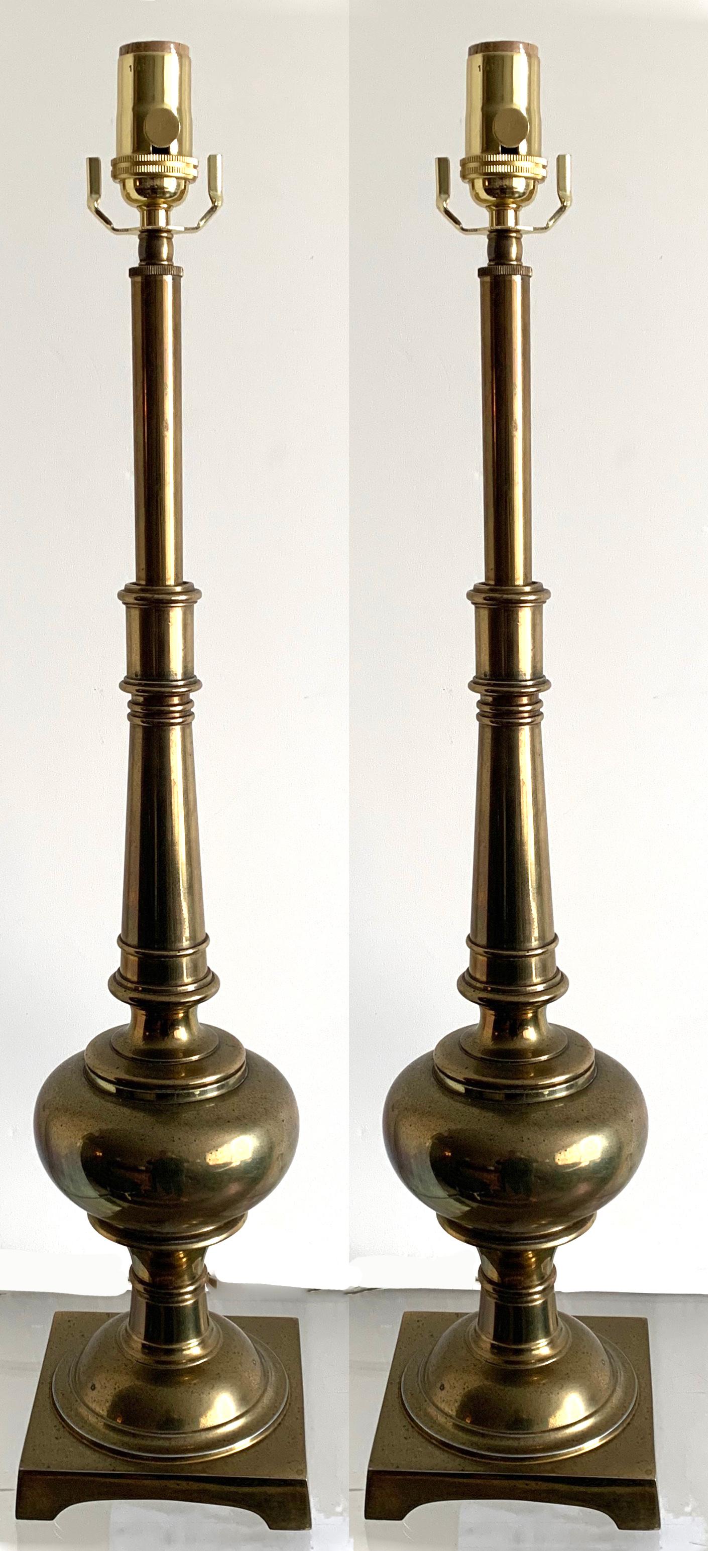 Pair of 1970s tall heavy brass lamps by Stiffel. Newly rewired with new brass sockets. Overall unpolished patina. Each lamps takes one standard bulb (not included). Lampshades are not included.