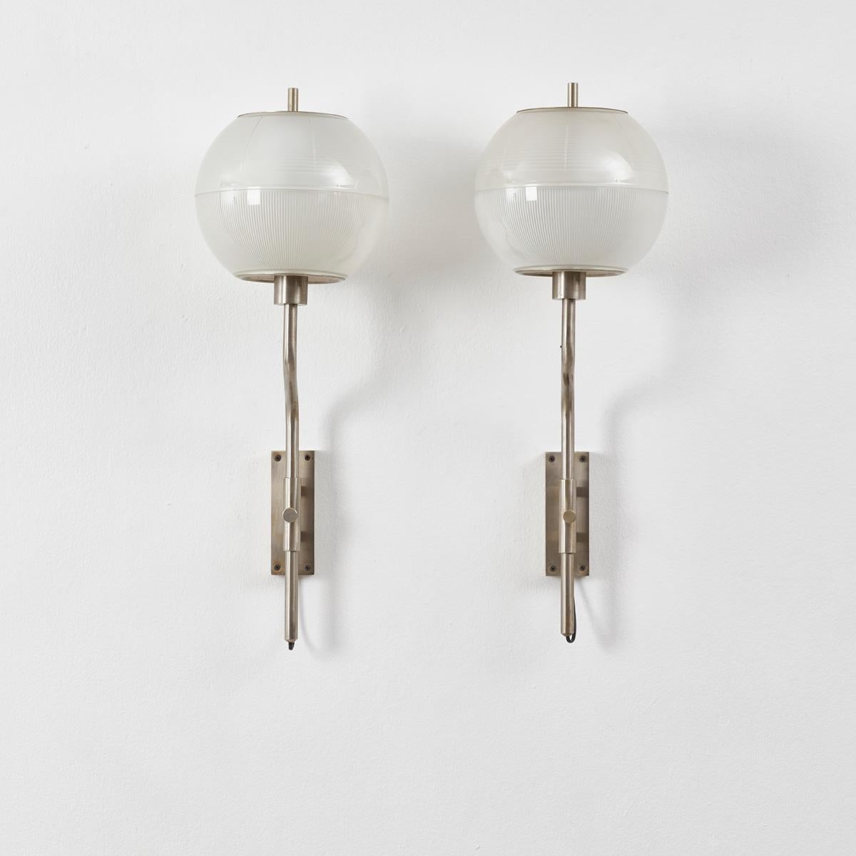 A pair glass globed wall nickel plated wall lamps by Stilnovo, in the manner of Luigi Caccia Dominioni and Sergio Mazza. They attach to the wall by a nickel mount, which holds cleverly placed screw allowing for the height of the lights to be