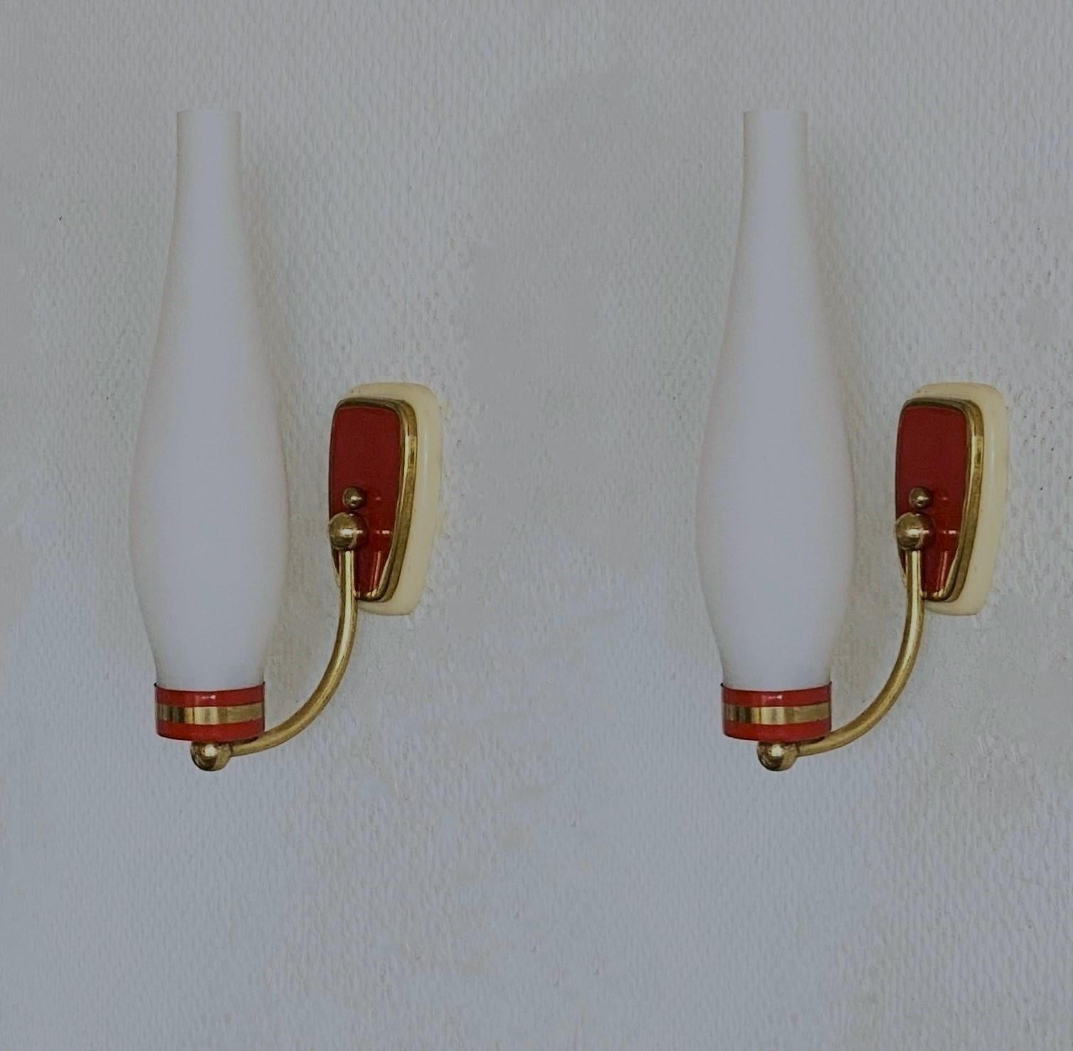 A lovely pair of wall sconces in Stilnovo style, Italy, 1960, modernist and clear lines design, brass galery with opal glass shades - the brass mounts are parcel red enameled. Both sconces in fine vintage condition, no damages, fully functional.