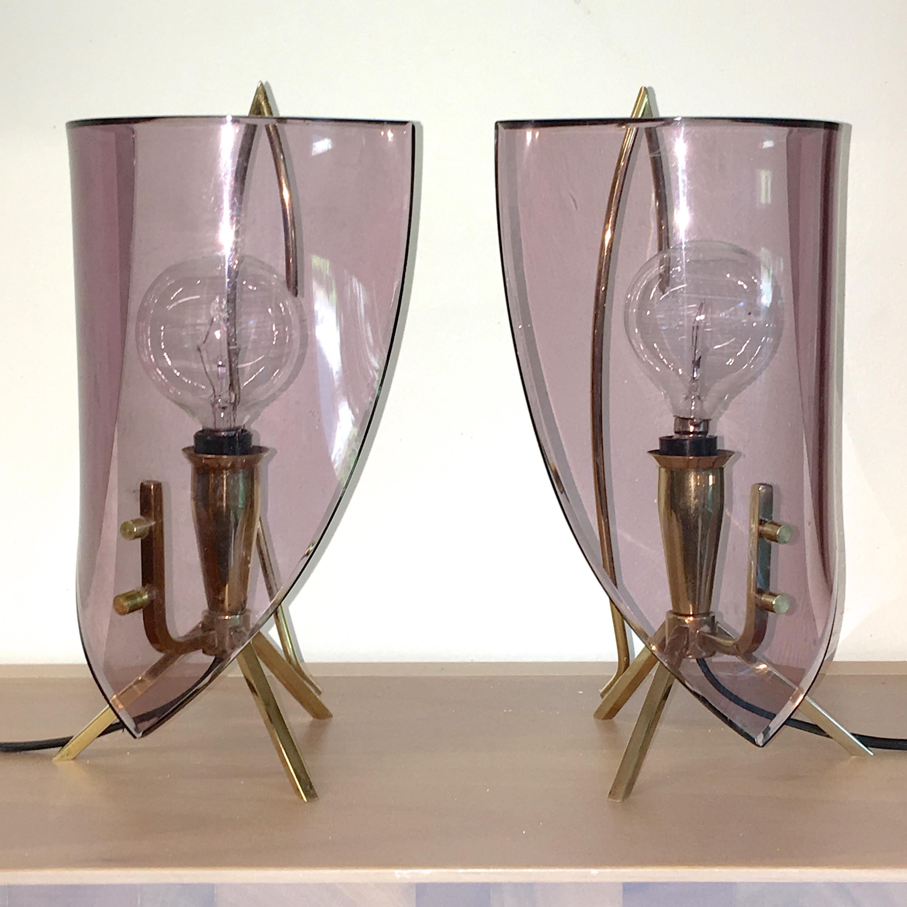 Pair of 1950s Italian bedside table lamps produced by Stilux Milano and attributed to the designer Oscar Torlasco. 

Solid brass modernist structure, not unlike a candle stand, with tripod legs and a single candelabra bulb in tapered brass cone