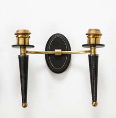 Pair of stitched leather wall light by Jacques Adnet