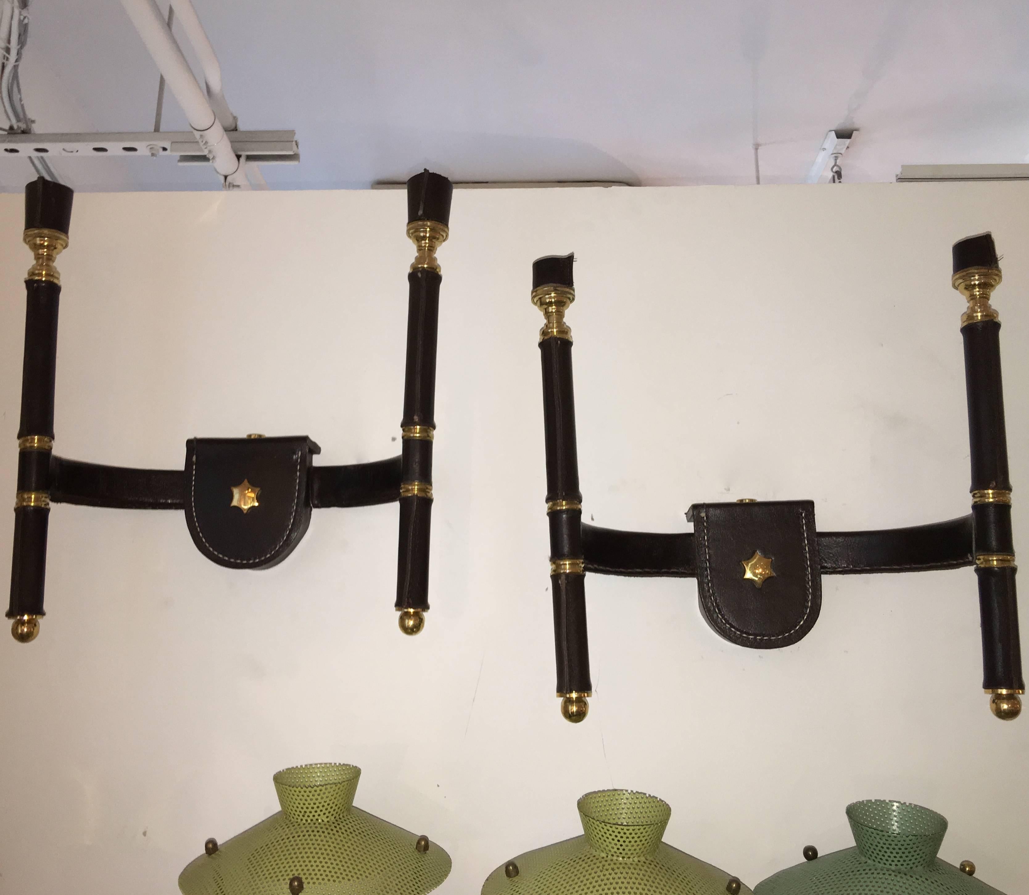 Entirely handcrafted by Beyond Gorgeosity's own artisans in our workshop/studio. 

These are the prototypes we produced for a client who required multiples of vintage French 1950s sconces by Jacques Adnet in saddle stitched black leather wrapped