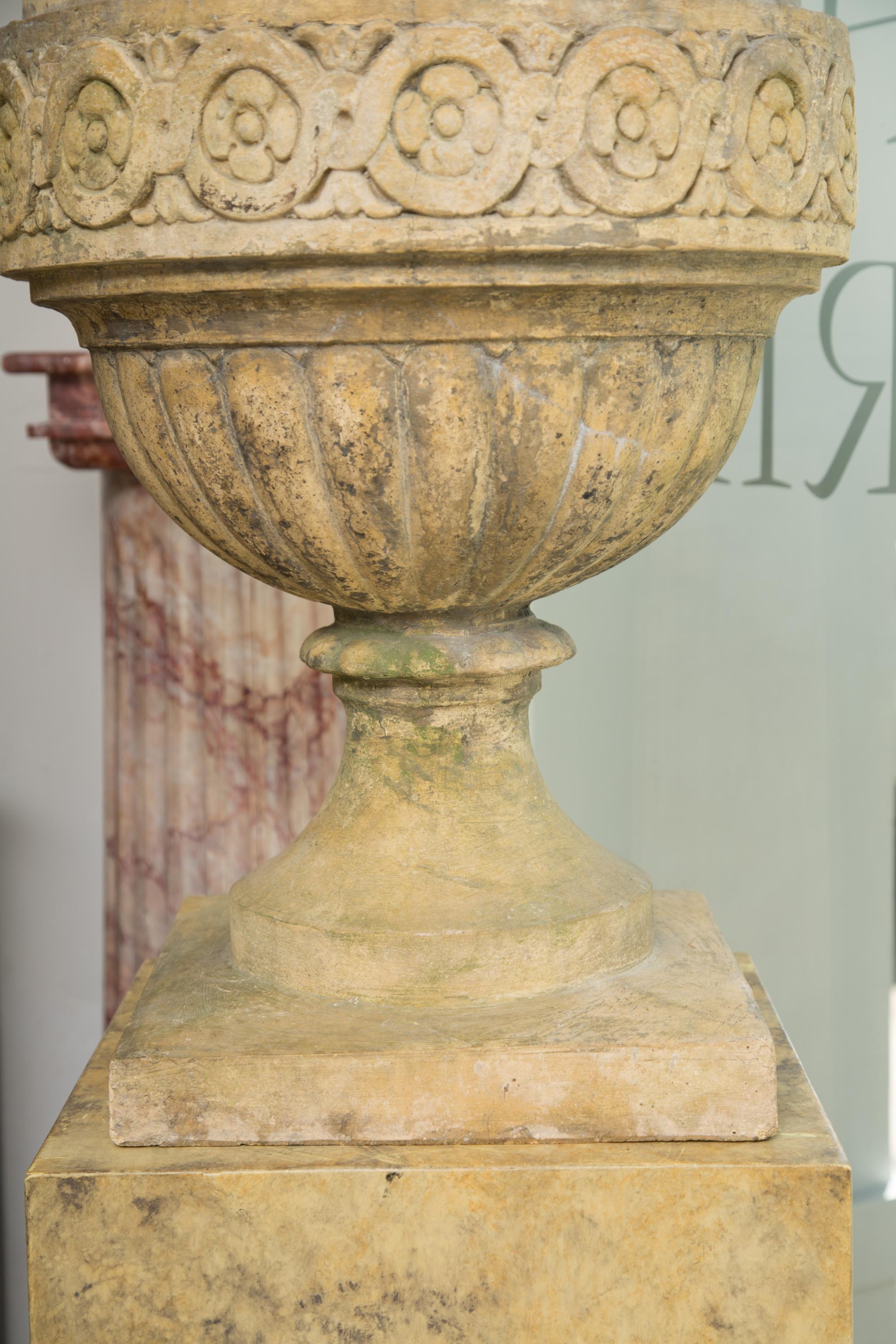 Pair of Stone Cast English Urns on Faux Marble Pedestals In Good Condition In WEST PALM BEACH, FL