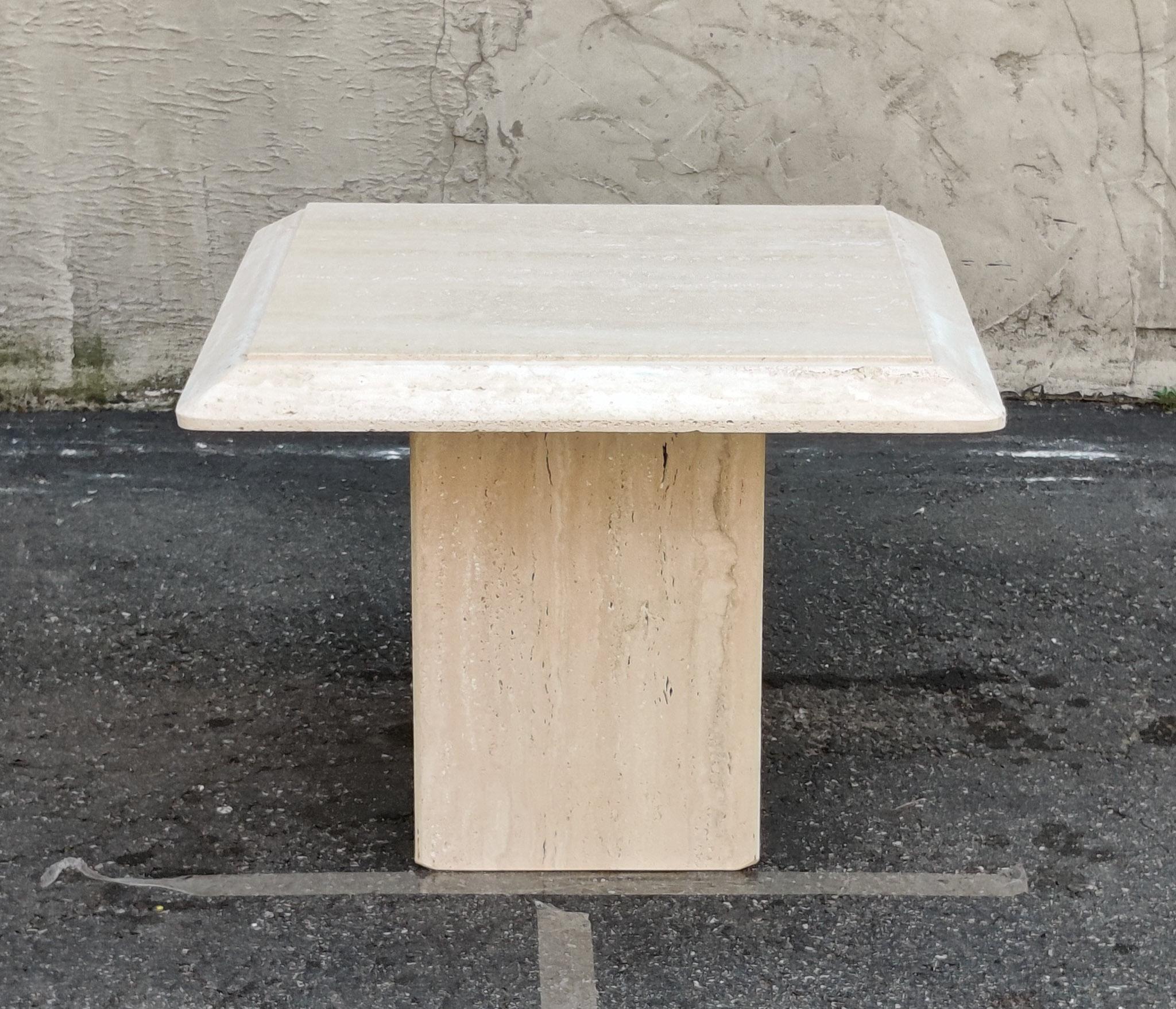 An amazing pair of Italian side tables with natural and porous travertine edging. The simplicity of the design and surface treatments is what makes this pair a classic example of strong and stoic Italian minimalist design, using top materials and
