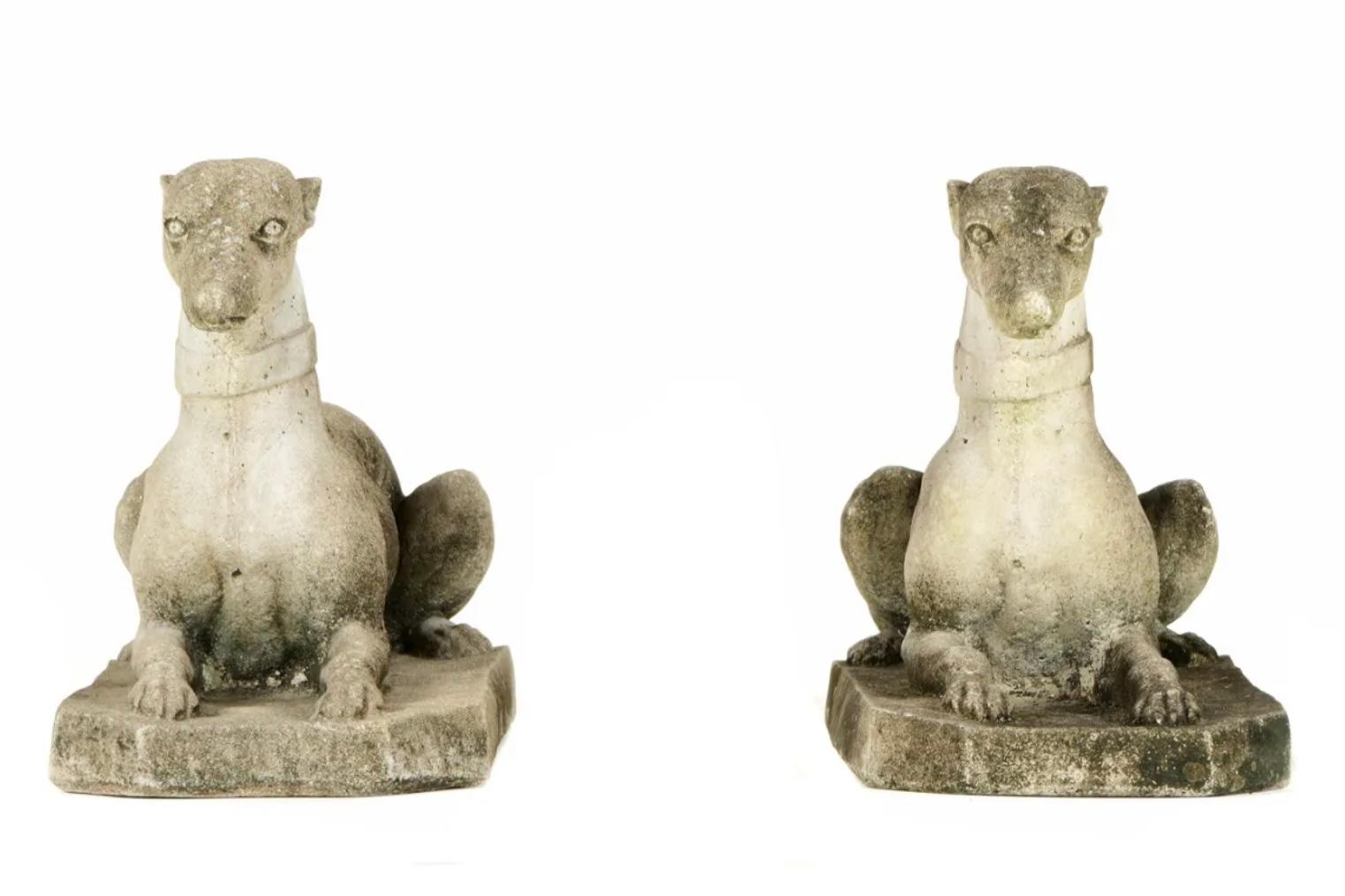 Pair of cast stone figural recumbent Italian Greyhound dogs with heads raised, alert and watchful. Dog figures rest on cast stone rectangular bases. Mossy growth enhances the features and makes these a great conversation piece for any garden or