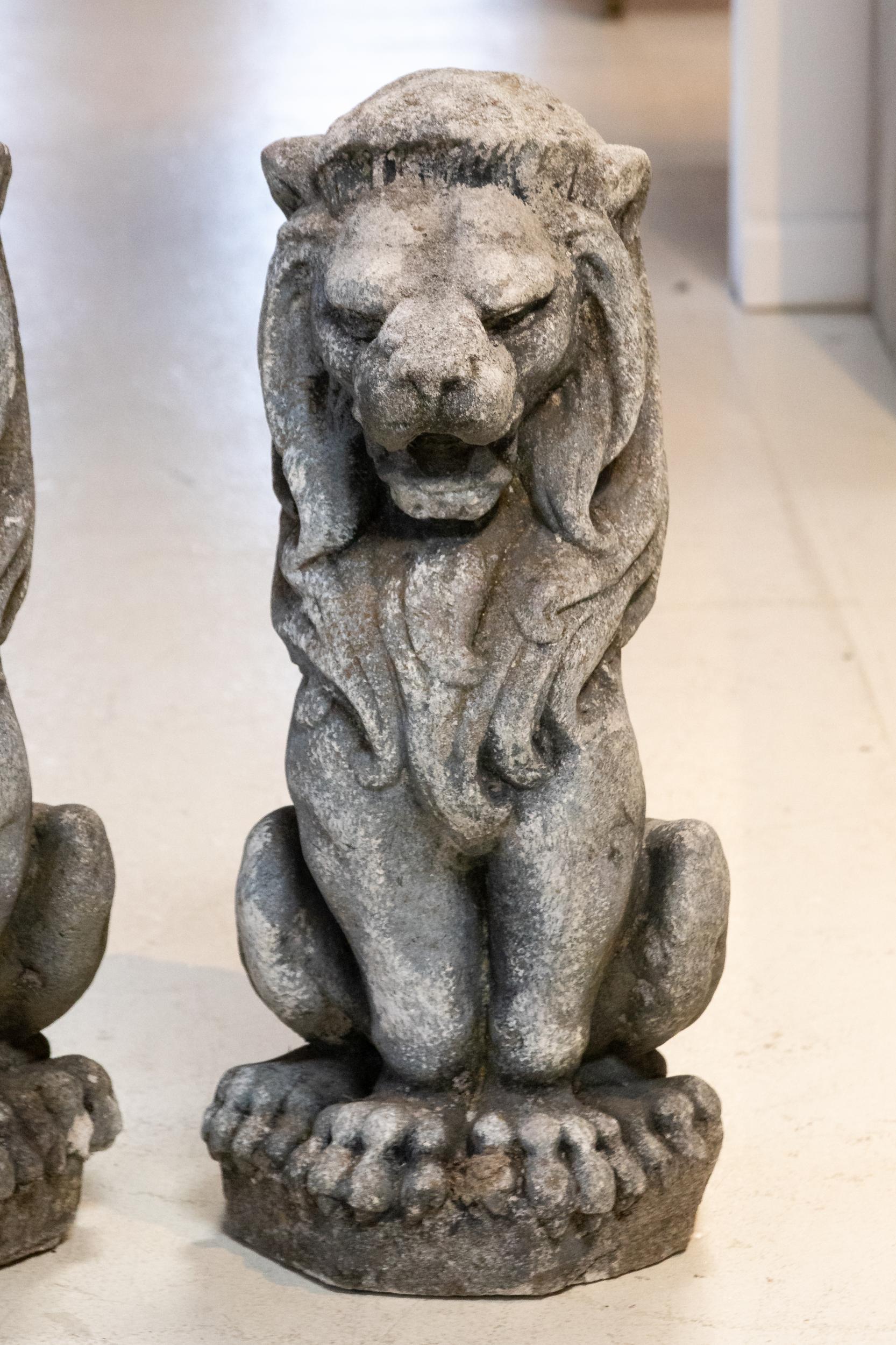 Cast stone lion garden ornaments, circa early 20th century. Please note of wear consistent with age including minor finish loss.