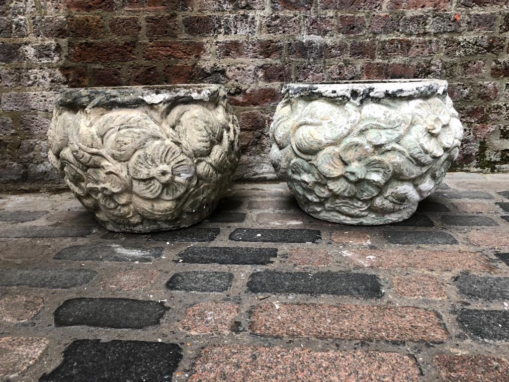 A gorgeous pair of stone planters, 19th century. With floral decoration, this pair have beautifully aged. The planters are reconstructed from stone, and are stunning when used in gardens and home decor.
Origin may possibly be from Liberty & Co.
  