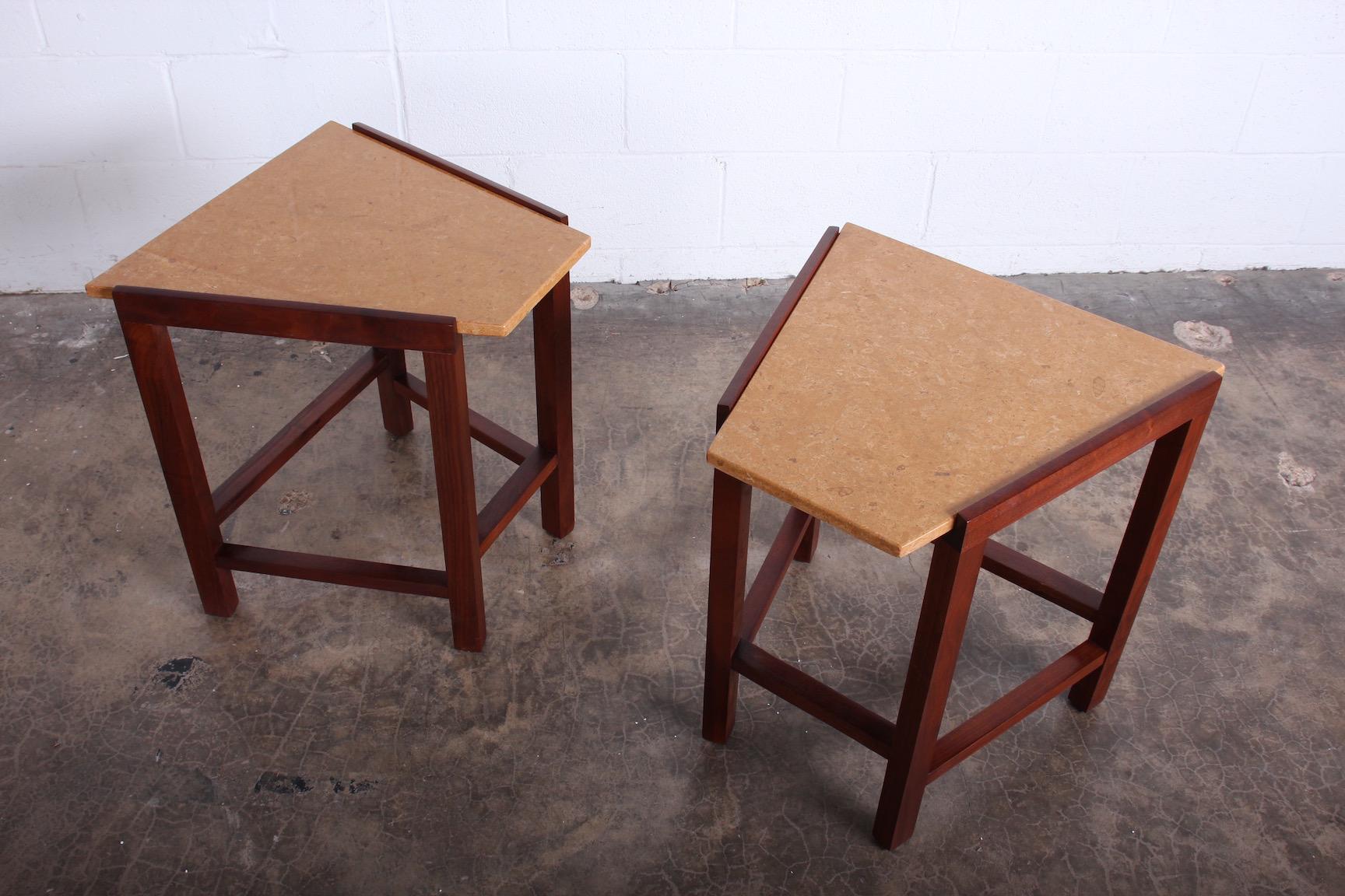A pair of walnut wedge side tables with stone tops. Designed by Edward Wormley for Dunbar.