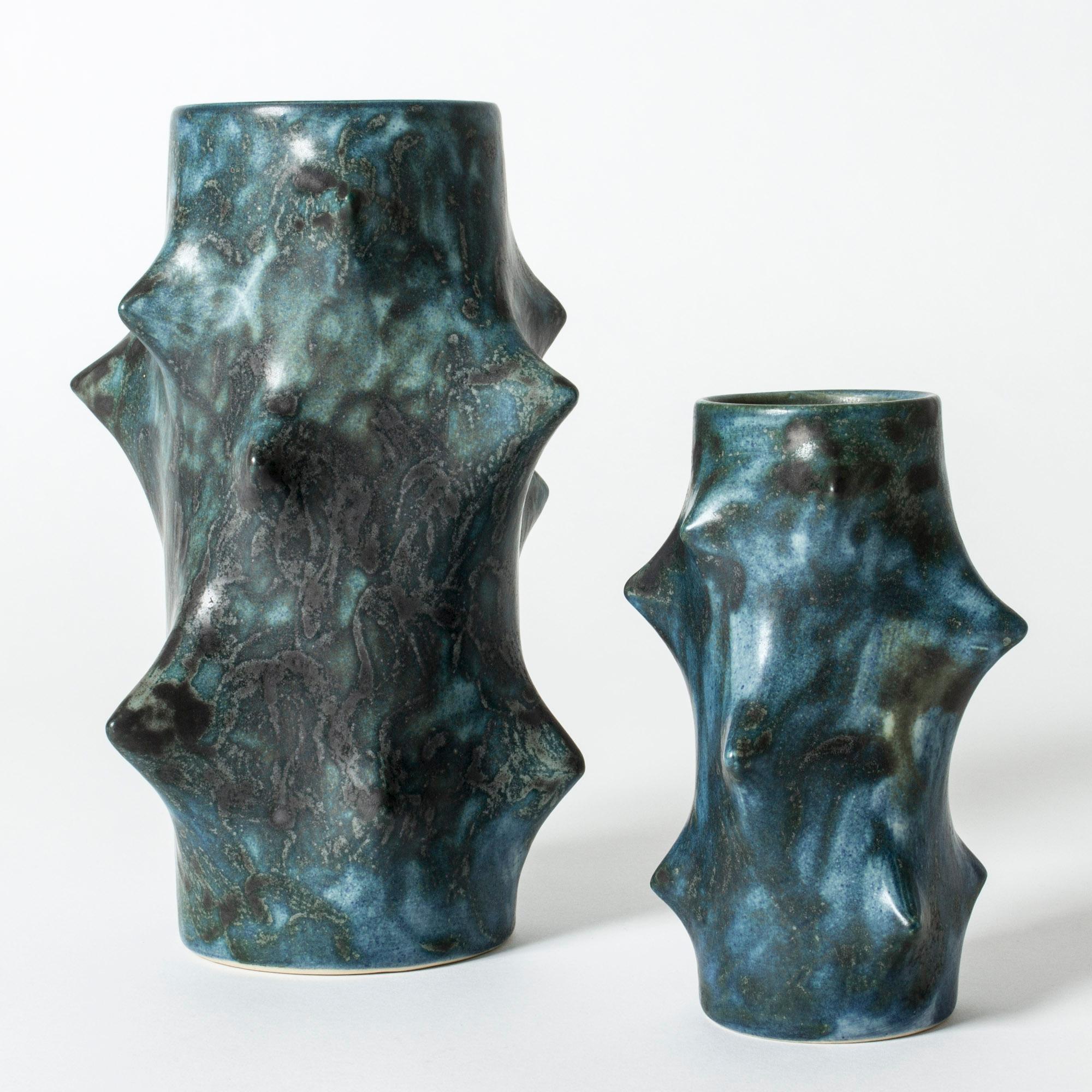 Pair stoneware vases by Knud Basse, in cactus-like forms, with points pressing outwards in a very expressive way. Dark petroleum colored glaze with nuances, metallic sheen.