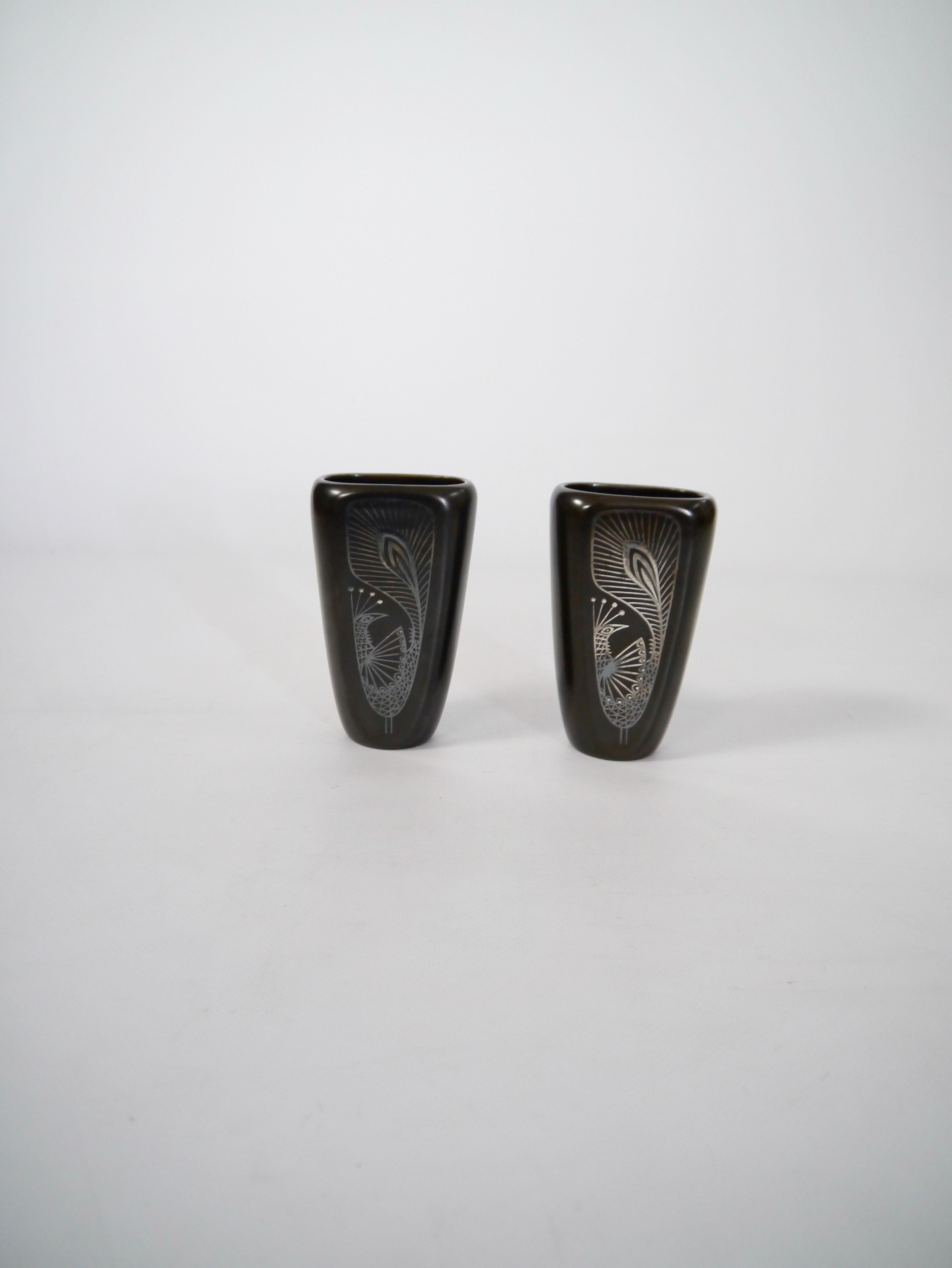 Pair of dark brown glazed stoneware vases, designed by Sven Jonson for Gustavsberg. Overlay silver decor, stylised peacock to the front and sailing ship + fish to the back.