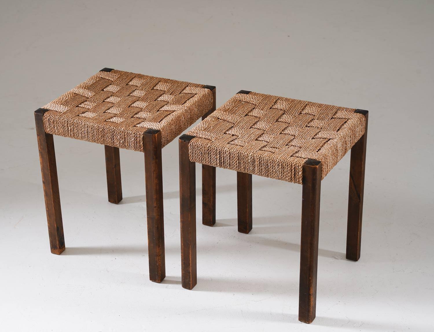 These Swedish modern stools designed by Axel Larsson for Bodafors in the 1930s offer a distinctive blend of craftsmanship and historical allure. Constructed from stained birch and featuring seagrass webbing, these stools epitomize the design