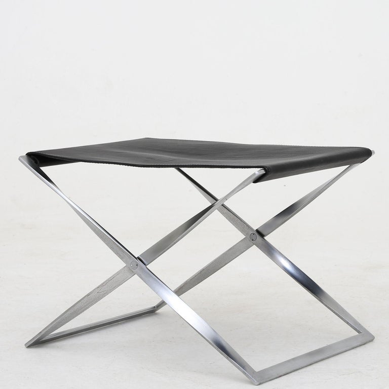 Set of two PK 91 - folding stools in steel and black leather. Poul Kjærholm / E. Kold Christensen.