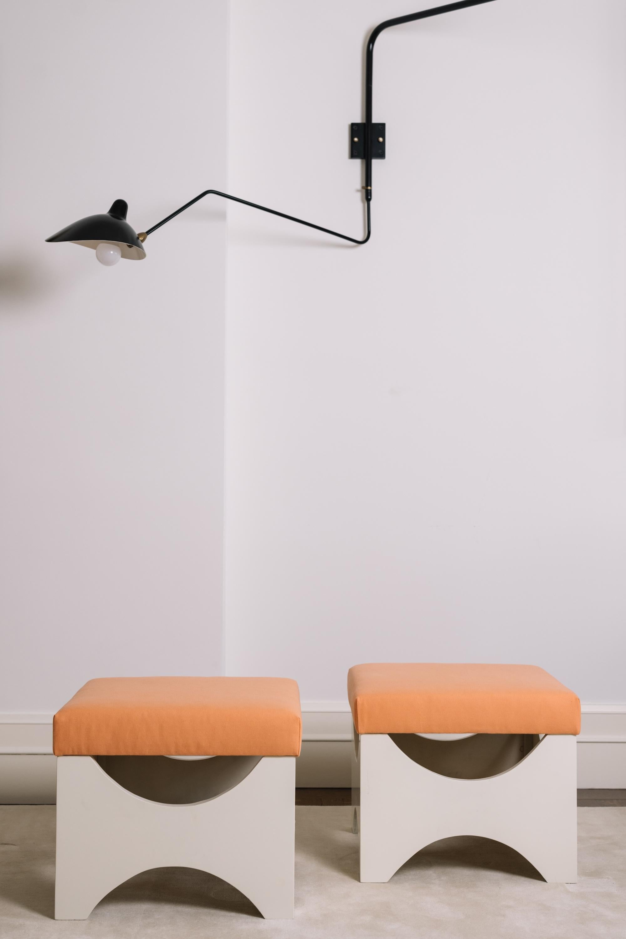 Ettore Sottsass’s Dado T29 stools for Poltronova distill his incisive blend of geometry and comfort. Made in Italy, circa 1960, the pair features clean, architectural wooden frames paired with the richness of original cotton upholstery—a study in