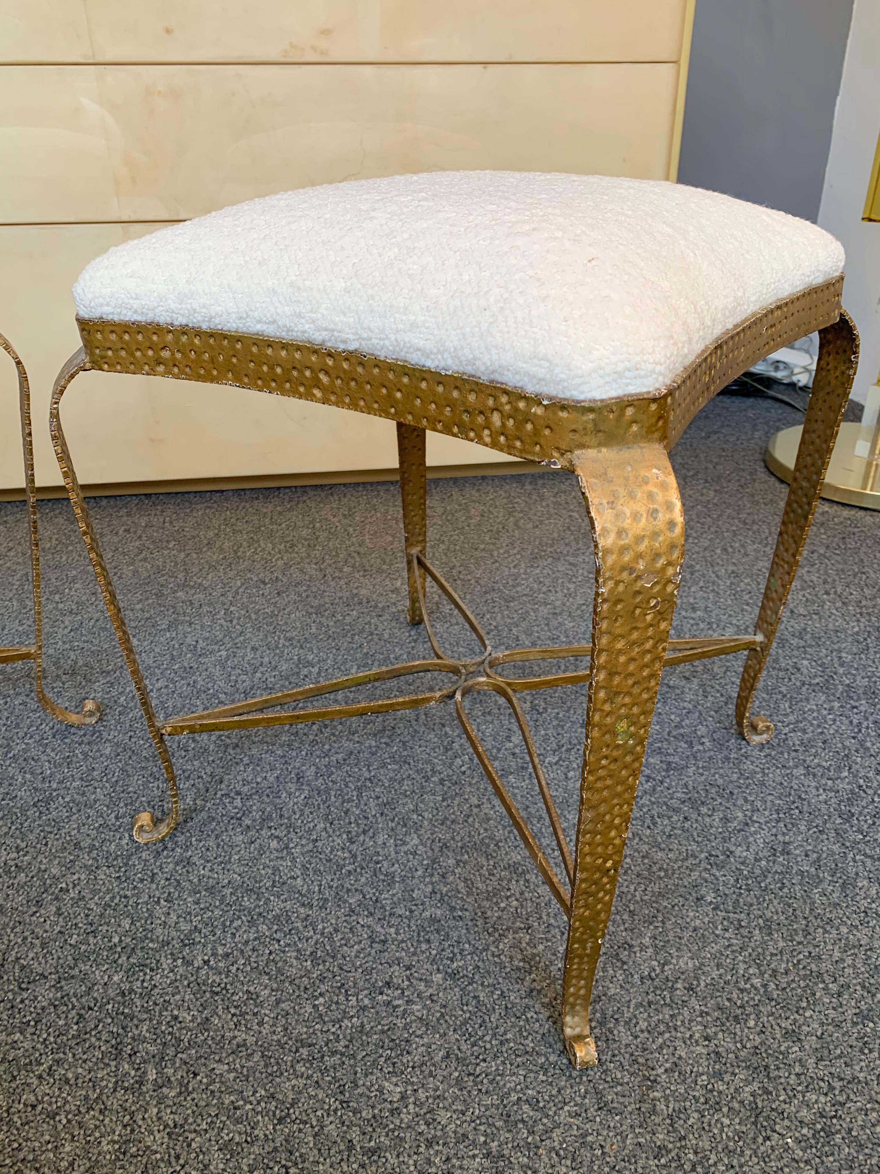 Pair of stools, poufs or ottomans by Pier Luigi Colli. Hammered wrought iron and gold leaf. Fully upholstered in bouclé fabric. A bench are available on my storefront. Famous design like Maison Jansen, Baguès, Gilbert Poillerat, Raymond Subes,