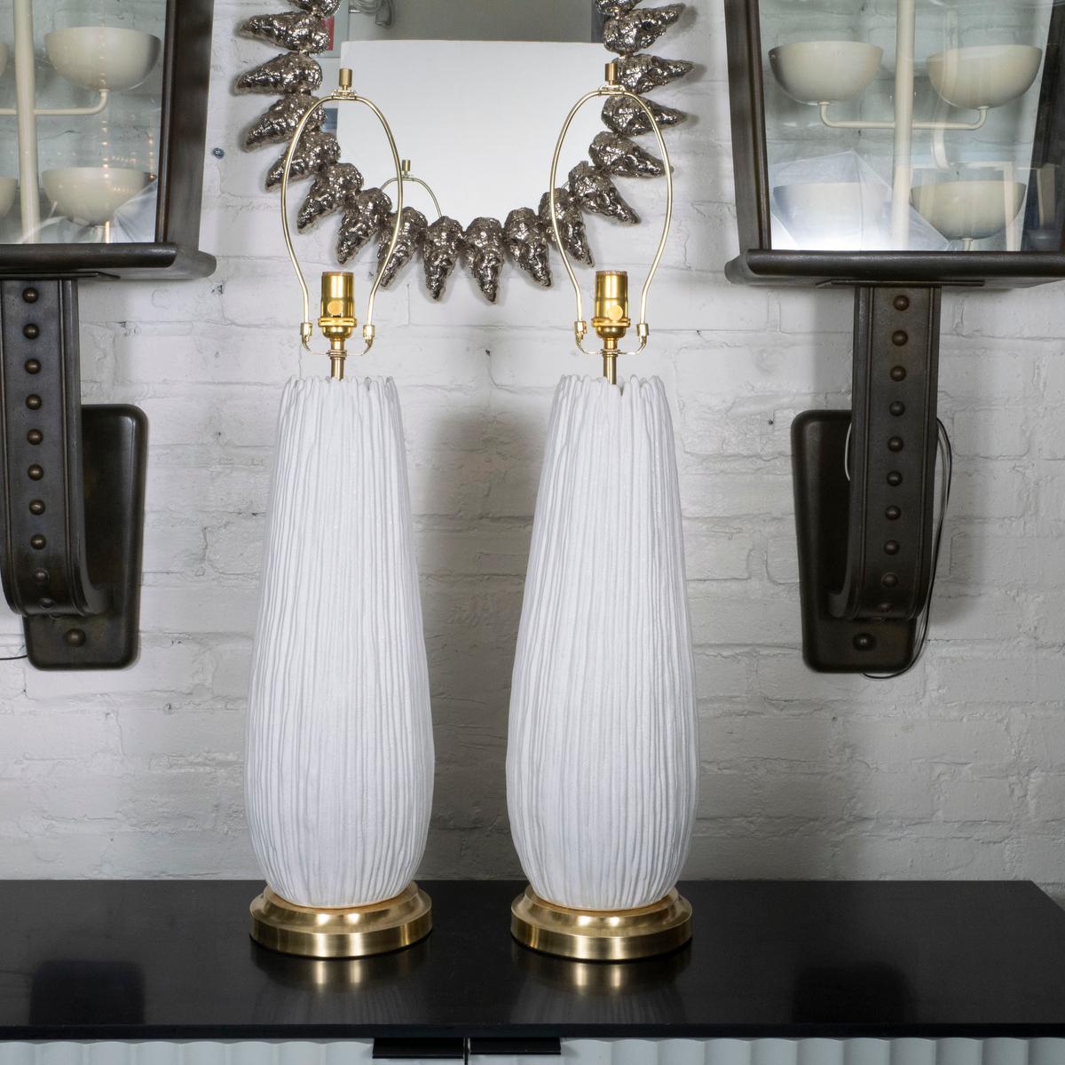 Pair of ceramic table lamps with textured, striated design.