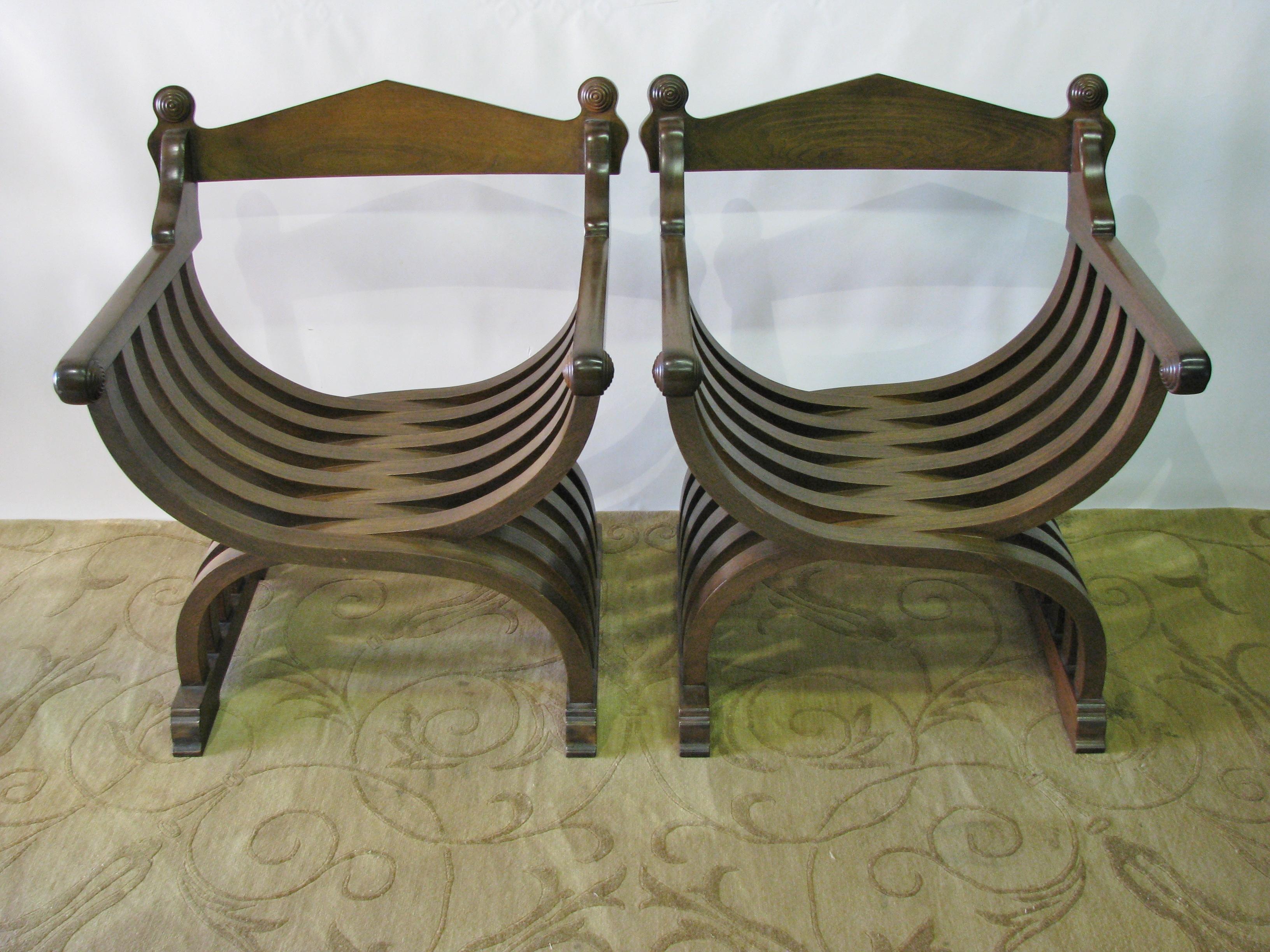 Striking pair of vintage 1960s walnut Savonarola chairs. Beautifully made and generously sized. Each has a separate cream upholstered cushion. Turned details on the back crest and arms. Medium-dark color and satin finish. Great looking from all