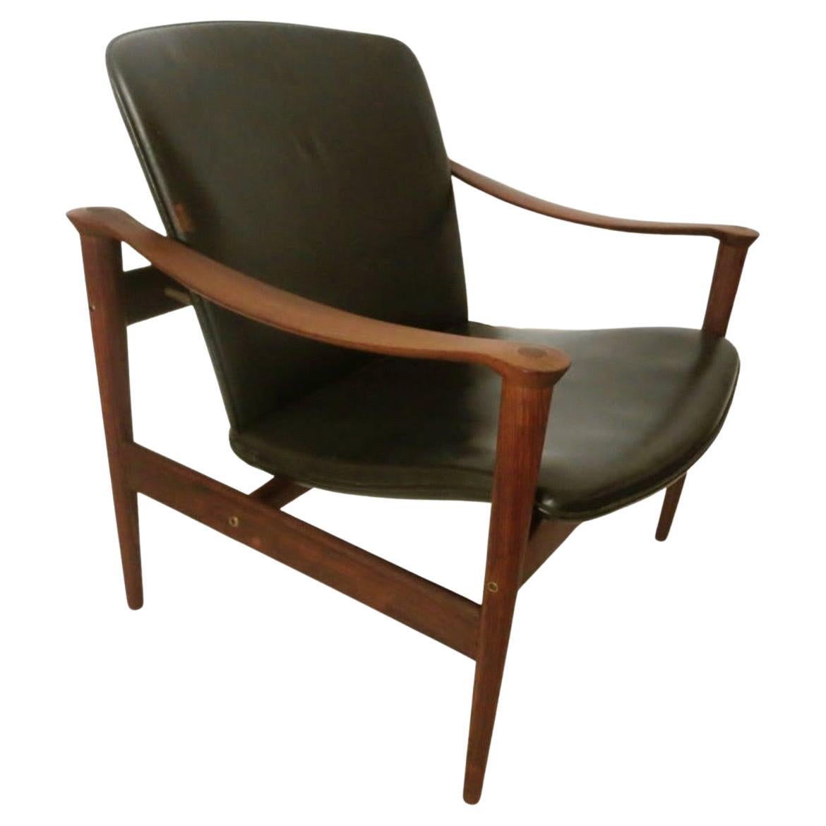 Elegant and unique pair of black leather and rosewood armchairs, designed by Fredrik Kayser, made in Norway the chairs are in great original condition, sculpted armrest, solid and sturdy, loveseat its also available, these chairs are hard to find .