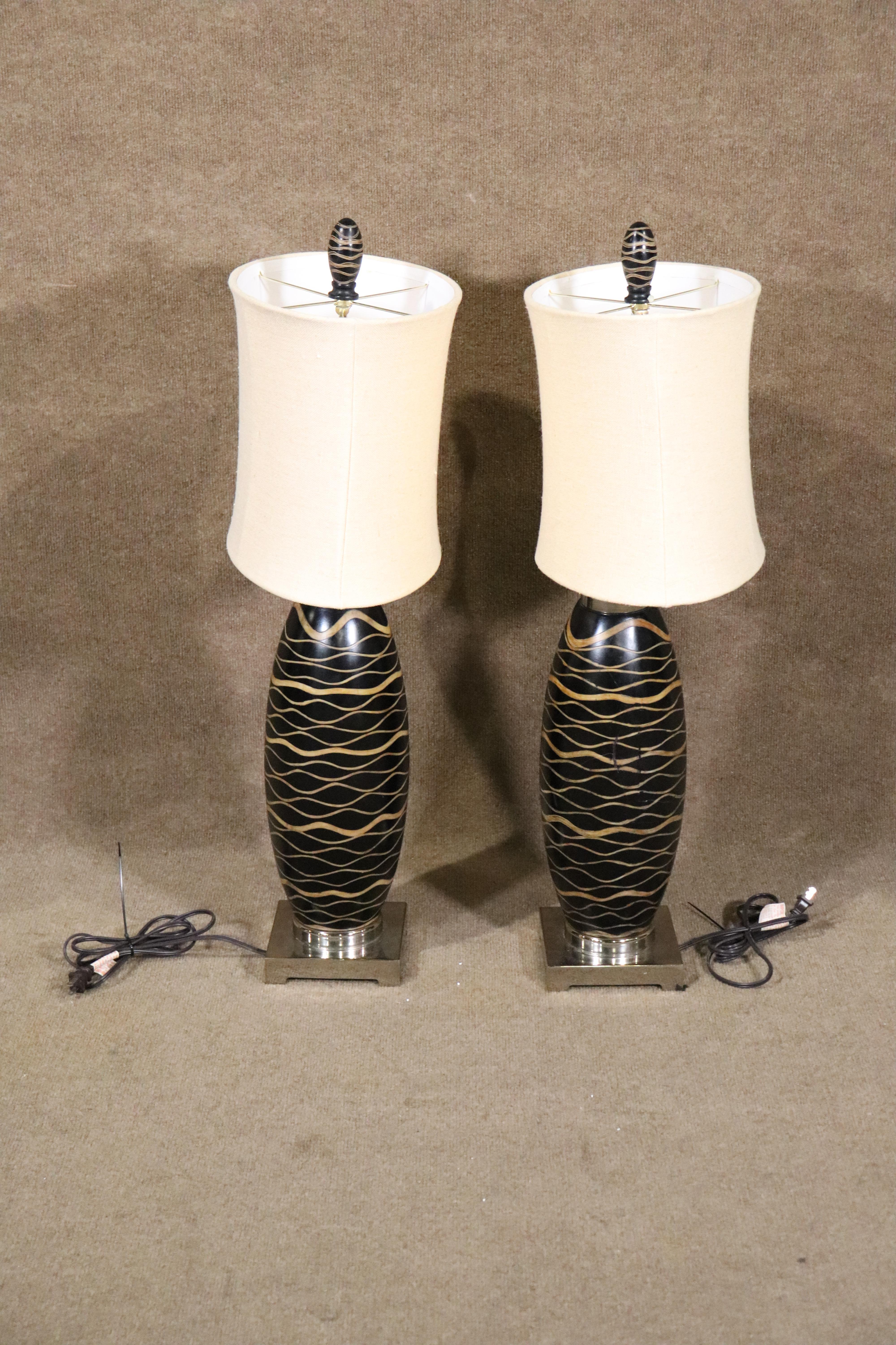 Pair of deco style table lamps with oval shades. Tiger wood motif around both lamps.
Please confirm item location NY or NJ.
