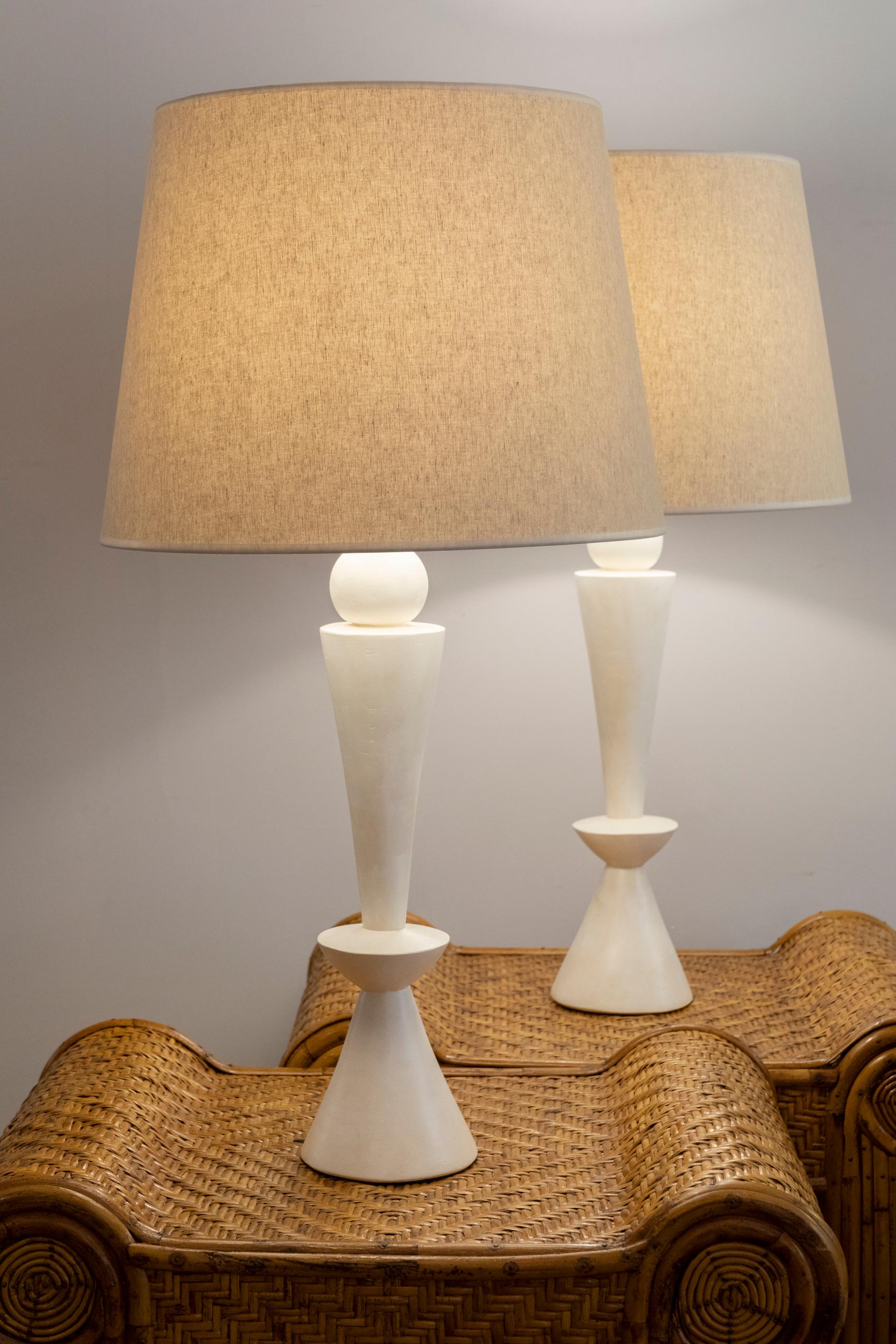 A pair of stuccoed plaster lamps.
France, contemporary creation.

Dimensions: 
Height total 86 cm (33.8 inches)
Height plaster foot 51 cm (20.1 inches)
Diameter 45 cm. (17.7 inches).
  