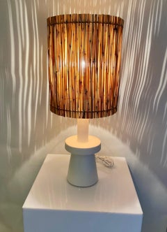 Pair of stuccoed plaster table lamps with straw shades