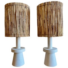 Pair of stuccoed plaster table lamps with straw shades